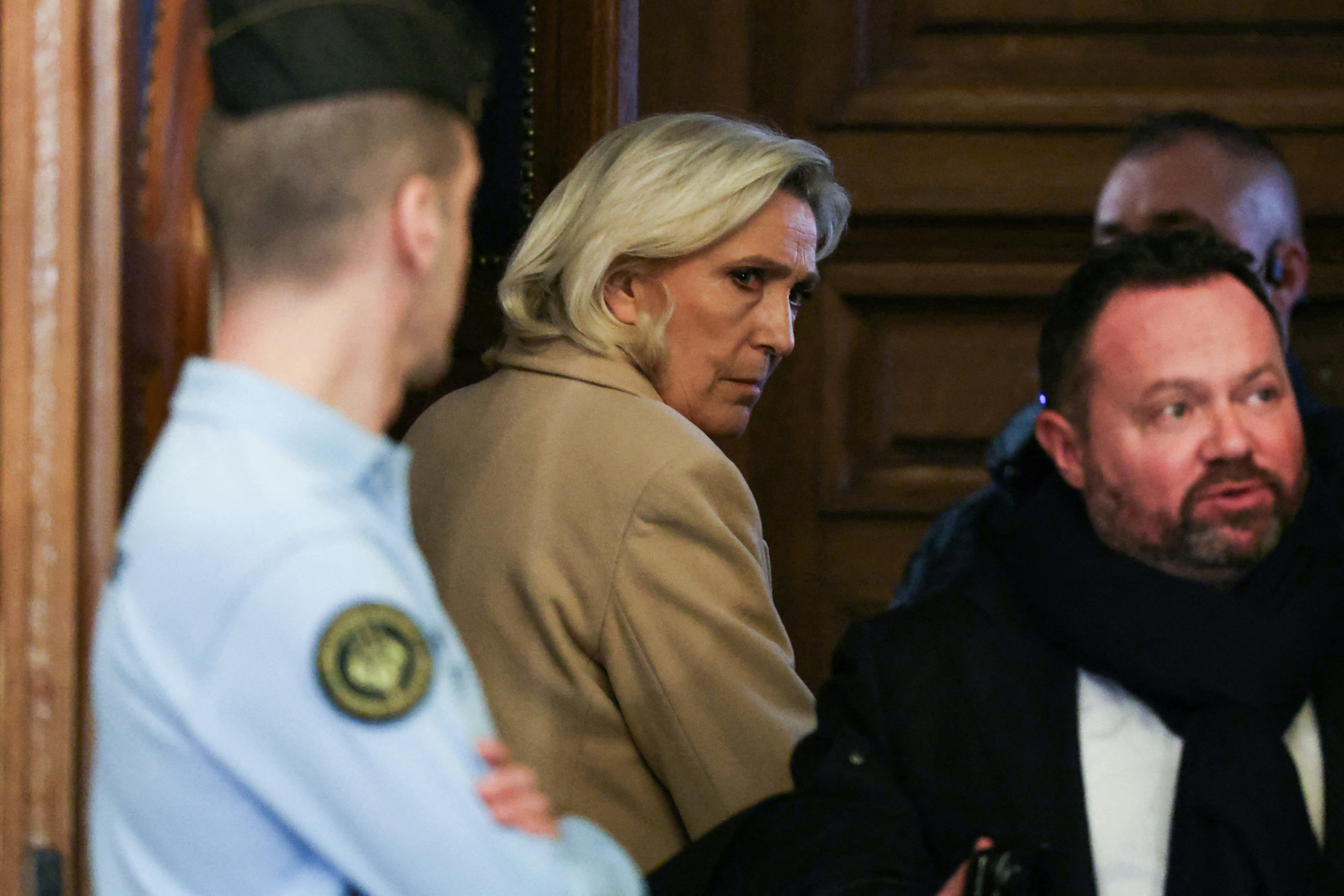 President of the parliamentary group of the French far-right Rassemblement National (RN) party, Marine Le Pen and and Rassemblement National's MP Bruno Bilde (R) leave the courtroom at the end of the first day of a hearing in her appeal trial on suspicion of embezzlement of European public funds, at Paris courthouse, on January 13, 2026.