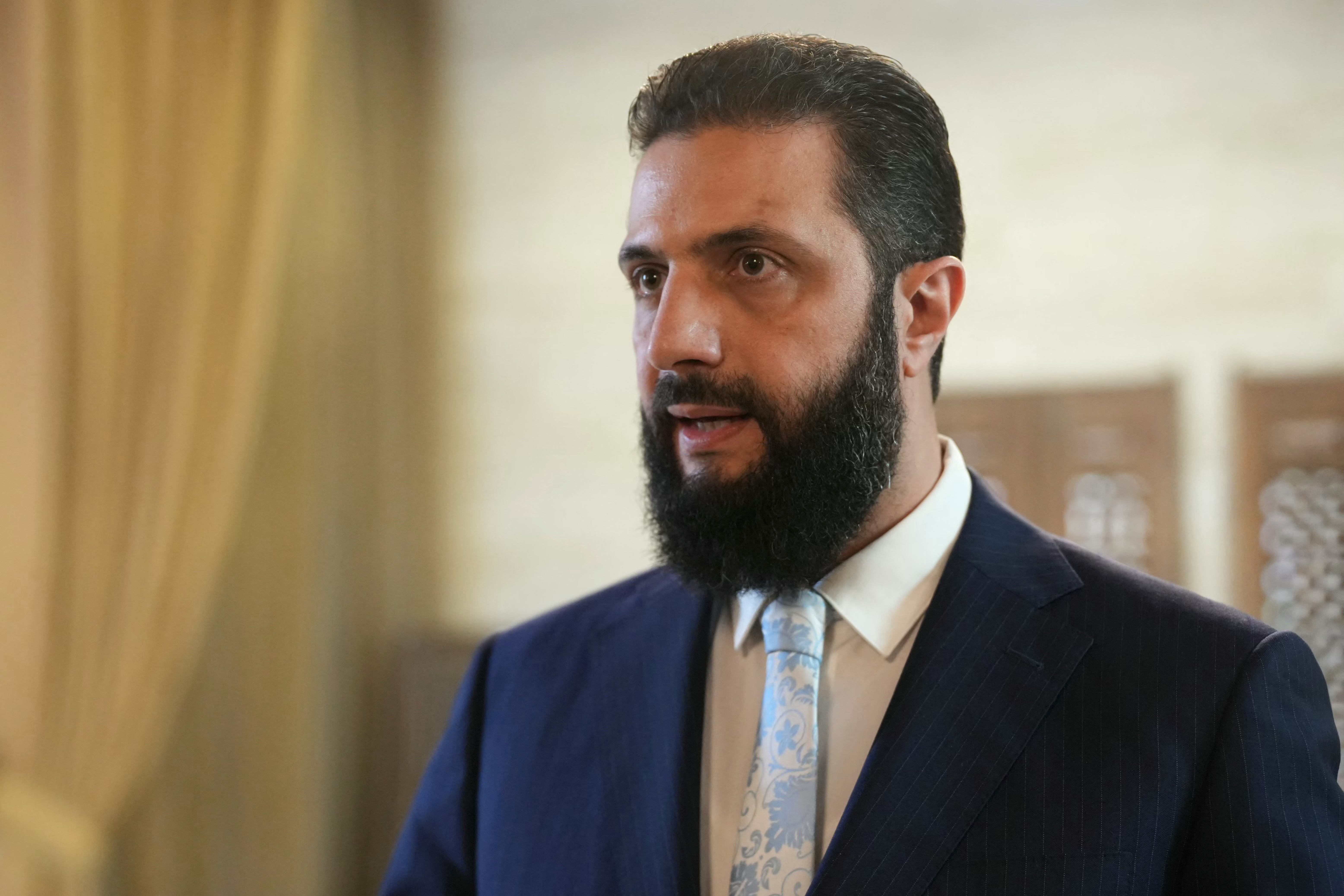 Syria's President Ahmed al-Sharaa speaks after signing an agreement at the Presidential Palace in Damascus