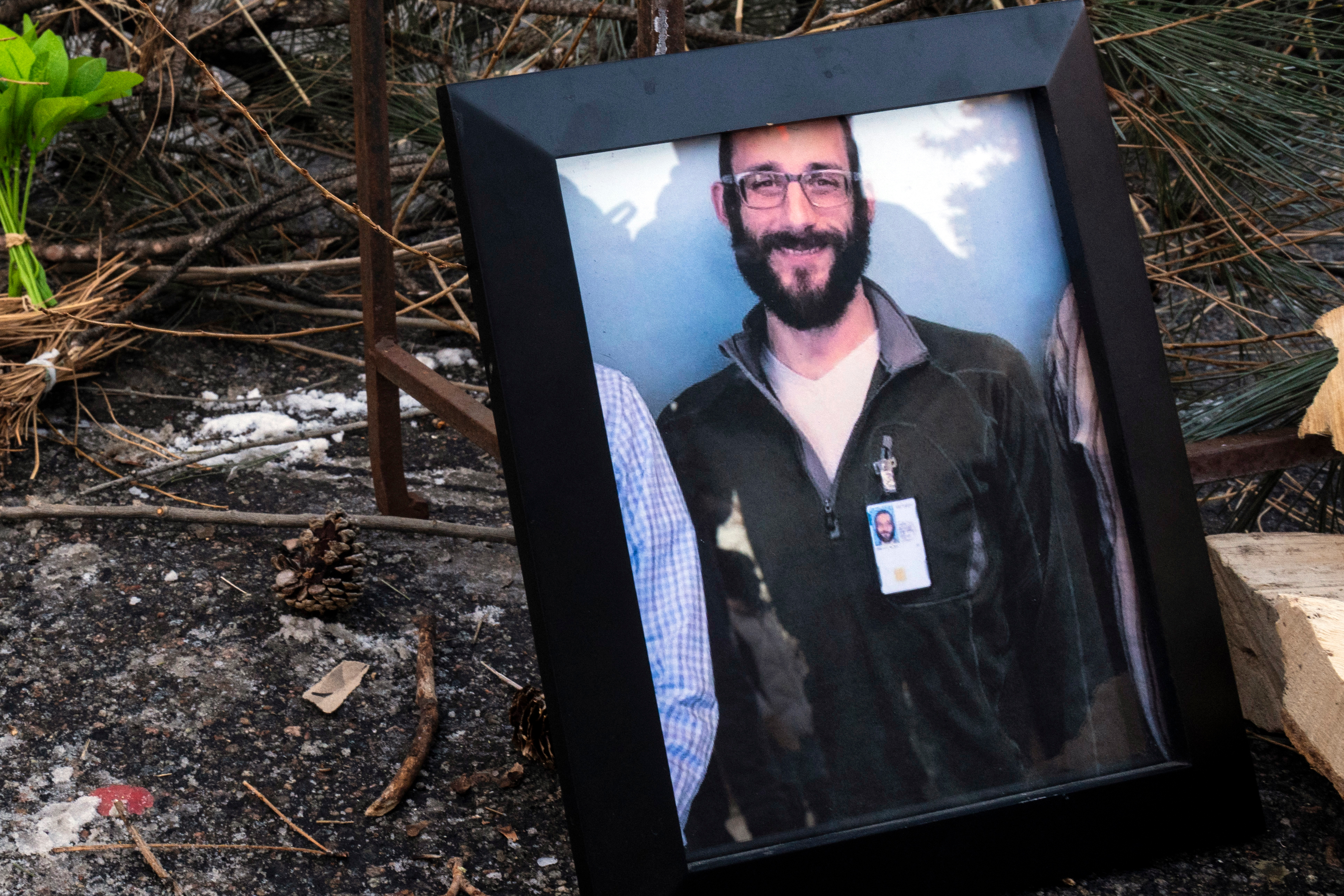 A photograph of 37-year-old Alex Pretti can be seen at a makeshift memorial in the area where he was shot dead by federal immigration agents earlier in the day in Minneapolis, Minnesota, on January 24, 2026. Federal immigration agents shot dead a man in Minneapolis on Saturday, in the second fatal shooting of a civilian during the Trump administration's unprecedented operation in the city, sparking fresh protests and outrage from state officials. The death came less than three weeks after US citizen Renee Good was shot and killed by an ICE officer. (Photo by ROBERTO SCHMIDT / AFP)