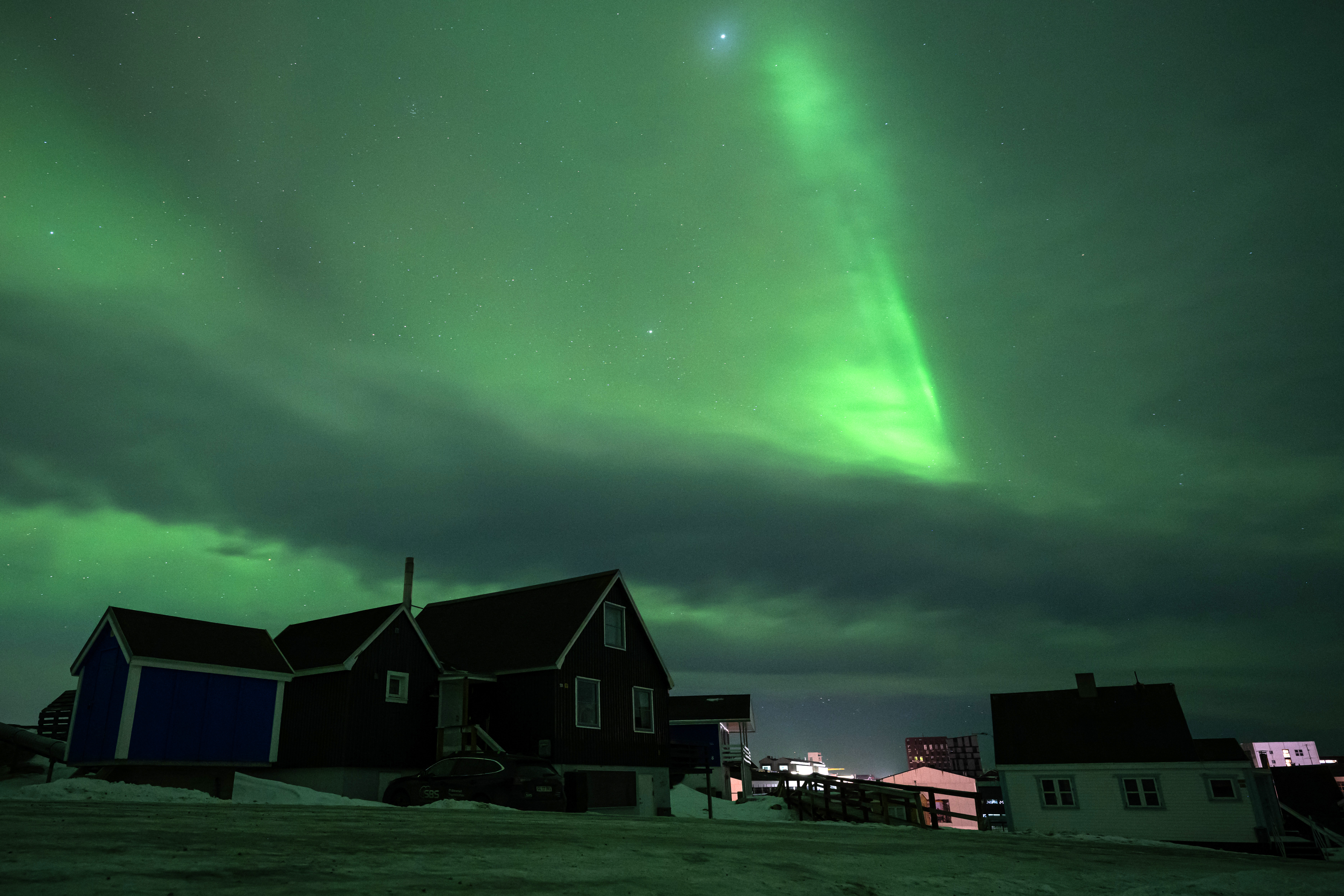 Northern Lights glow above the city of Nuuk during a power outage in Greenland
