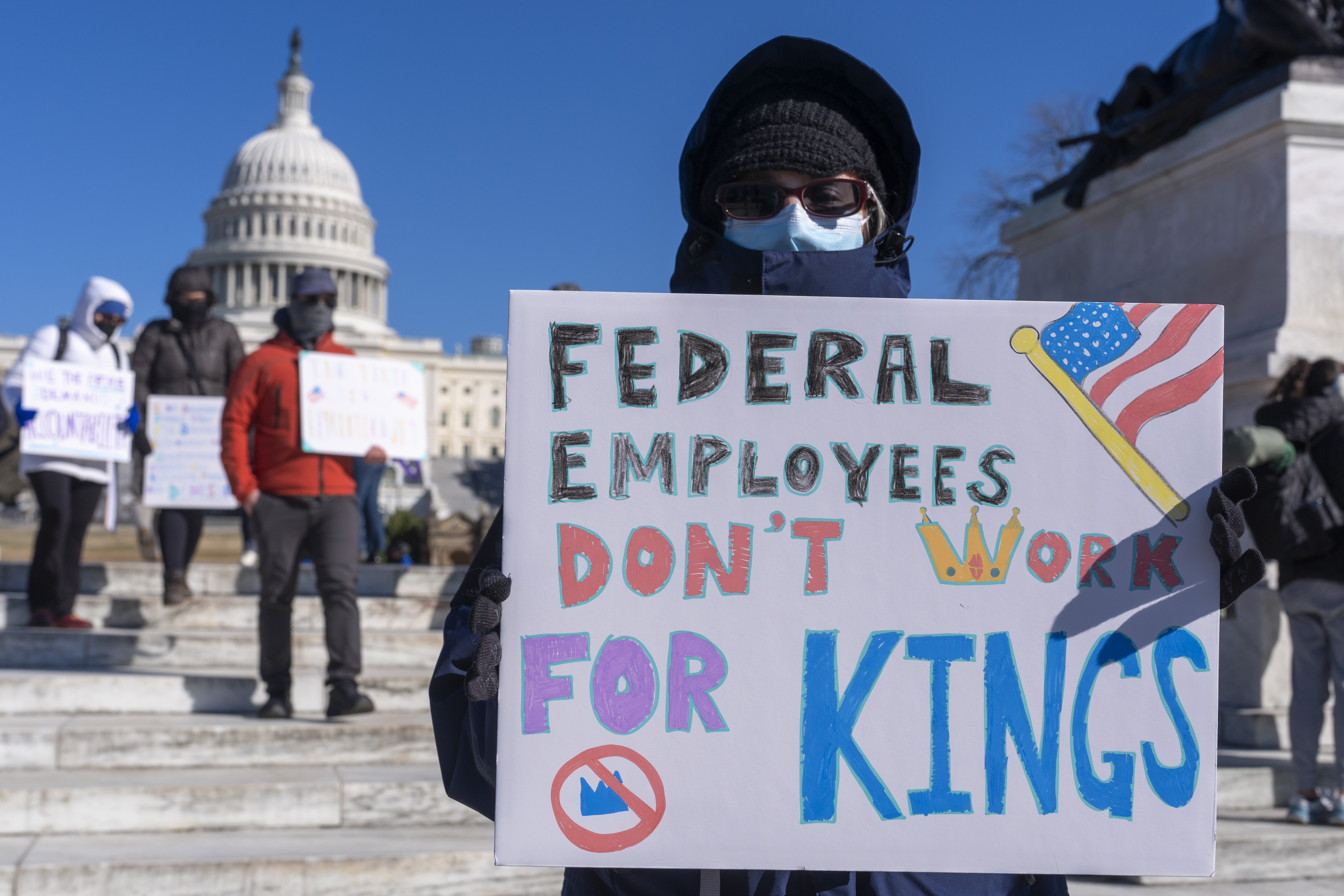 A protester demonstrates in front of the US Capitol to support federal employees.