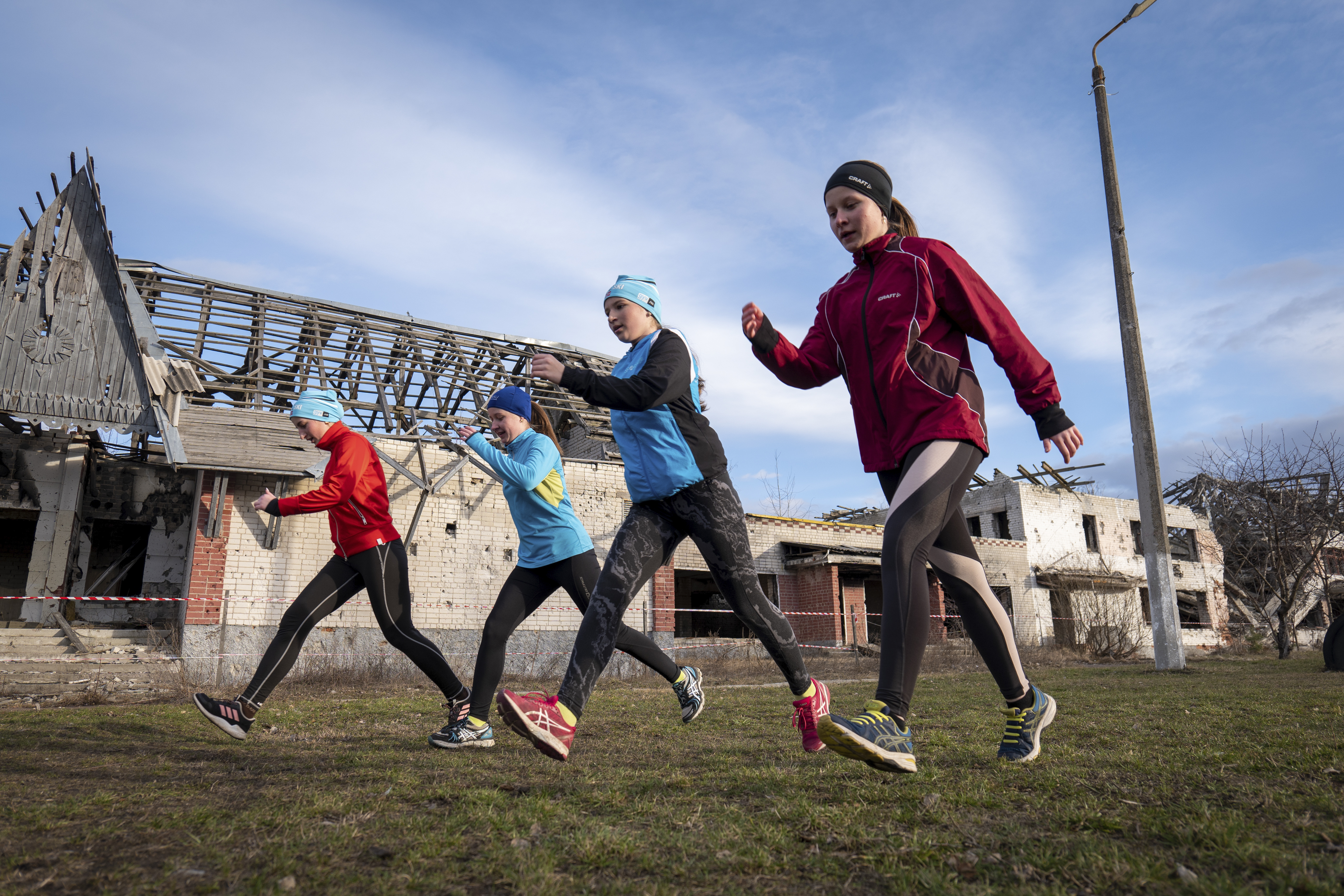 Children practice biathlon in front of the children Olympic reserve school, which was damaged during a Russian rocket attack, in Chernyhiv