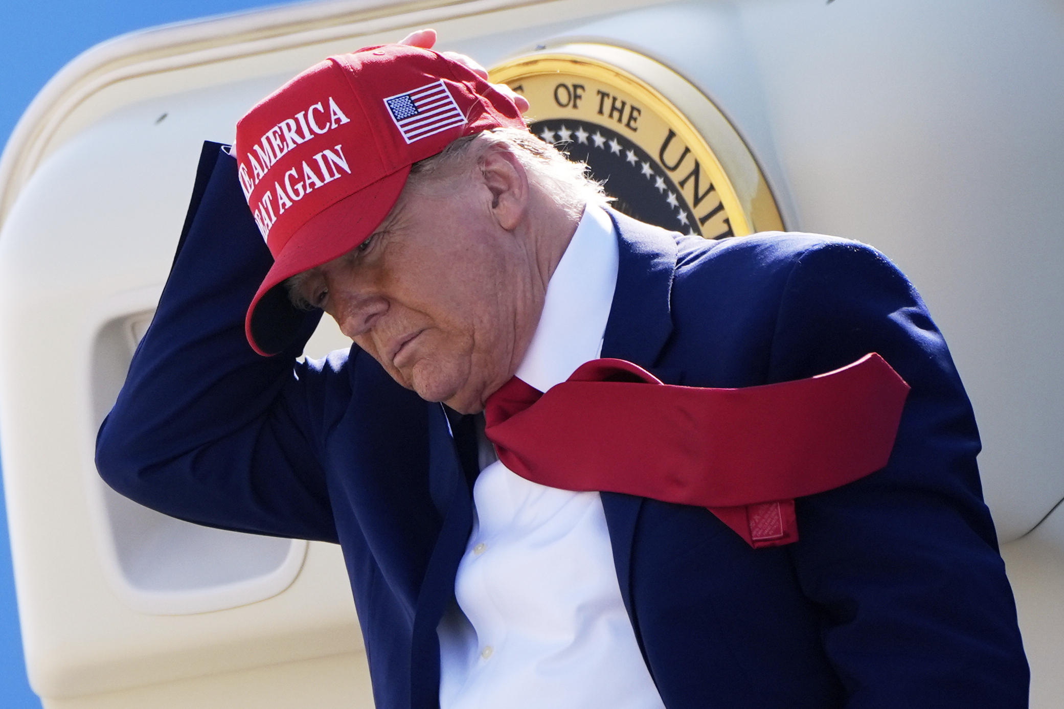 Trump holds onto his red baseball cap