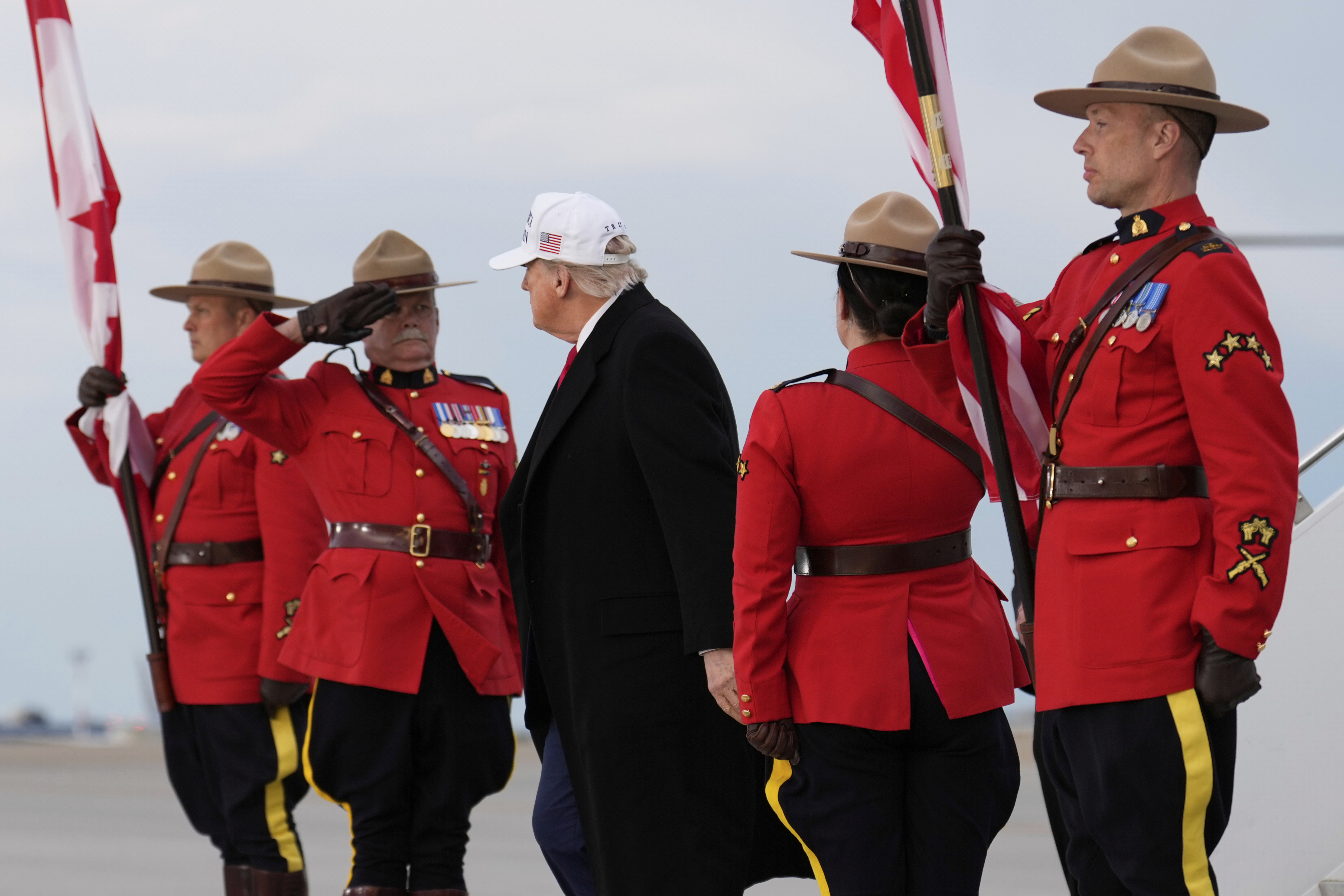 Trump walks past Mounties in Canada