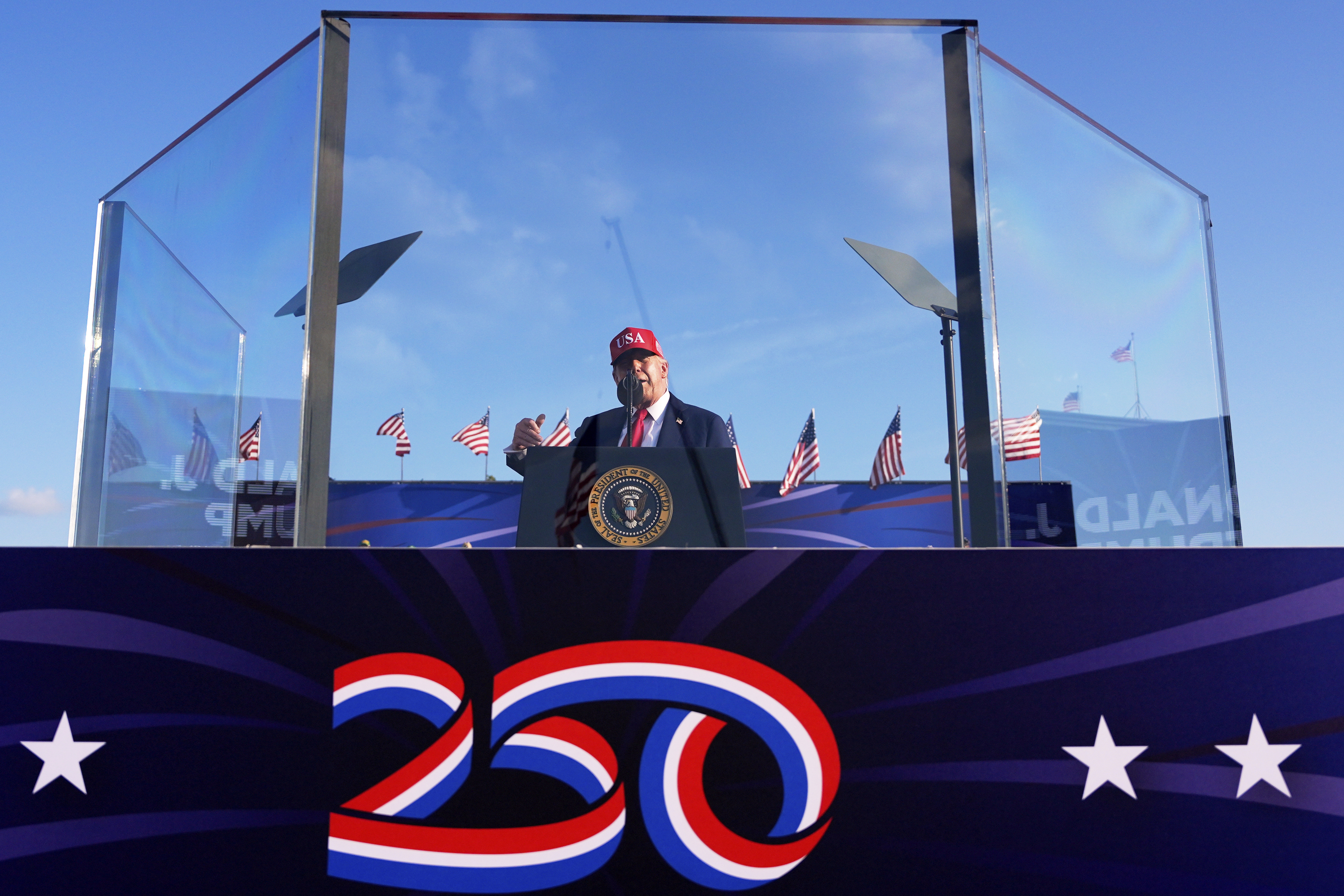 Trump speaks behind bullet-proof glass at the Iowa State Fairgrounds