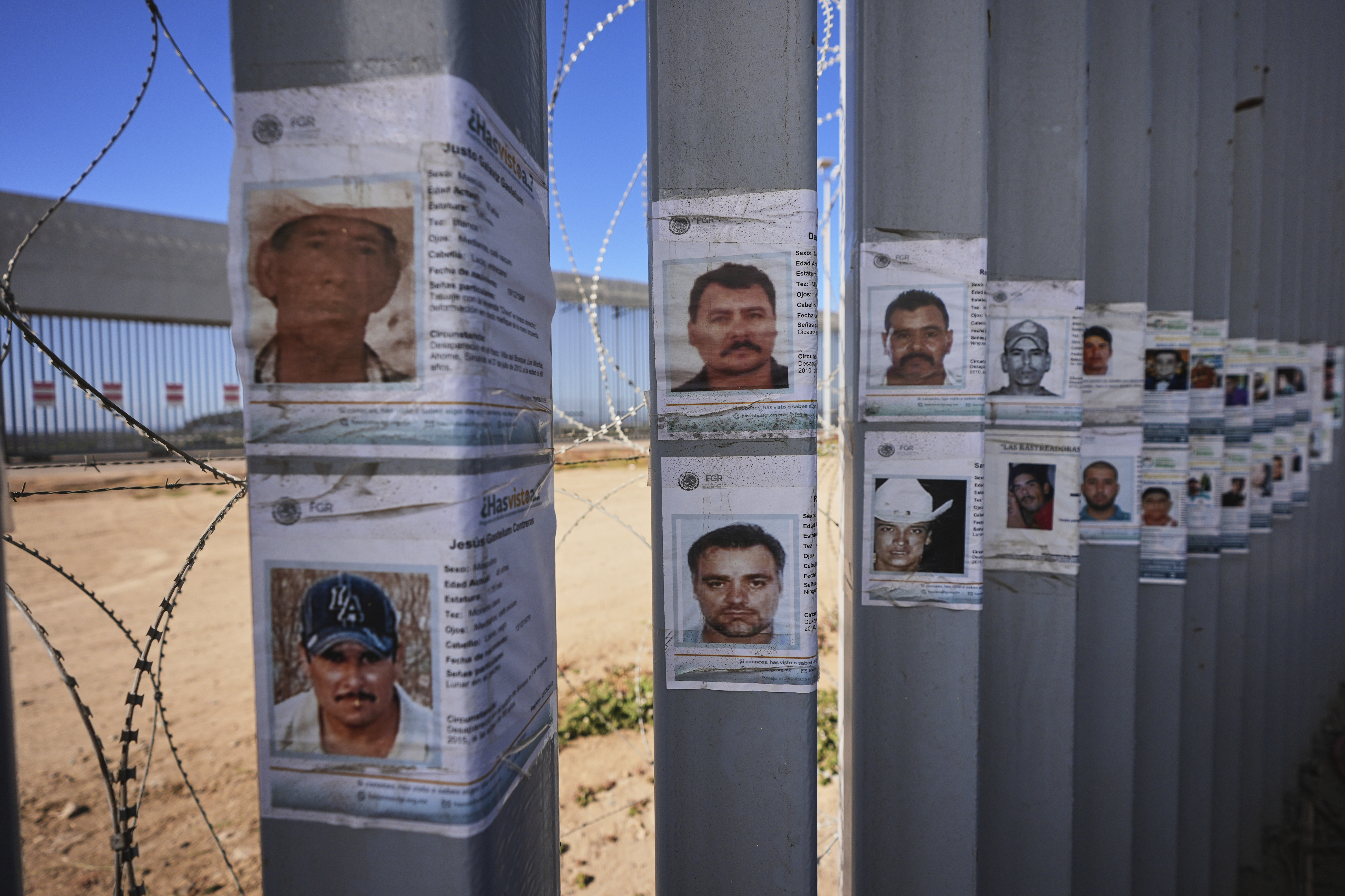 Missing people posters on the US-Mexico border wall