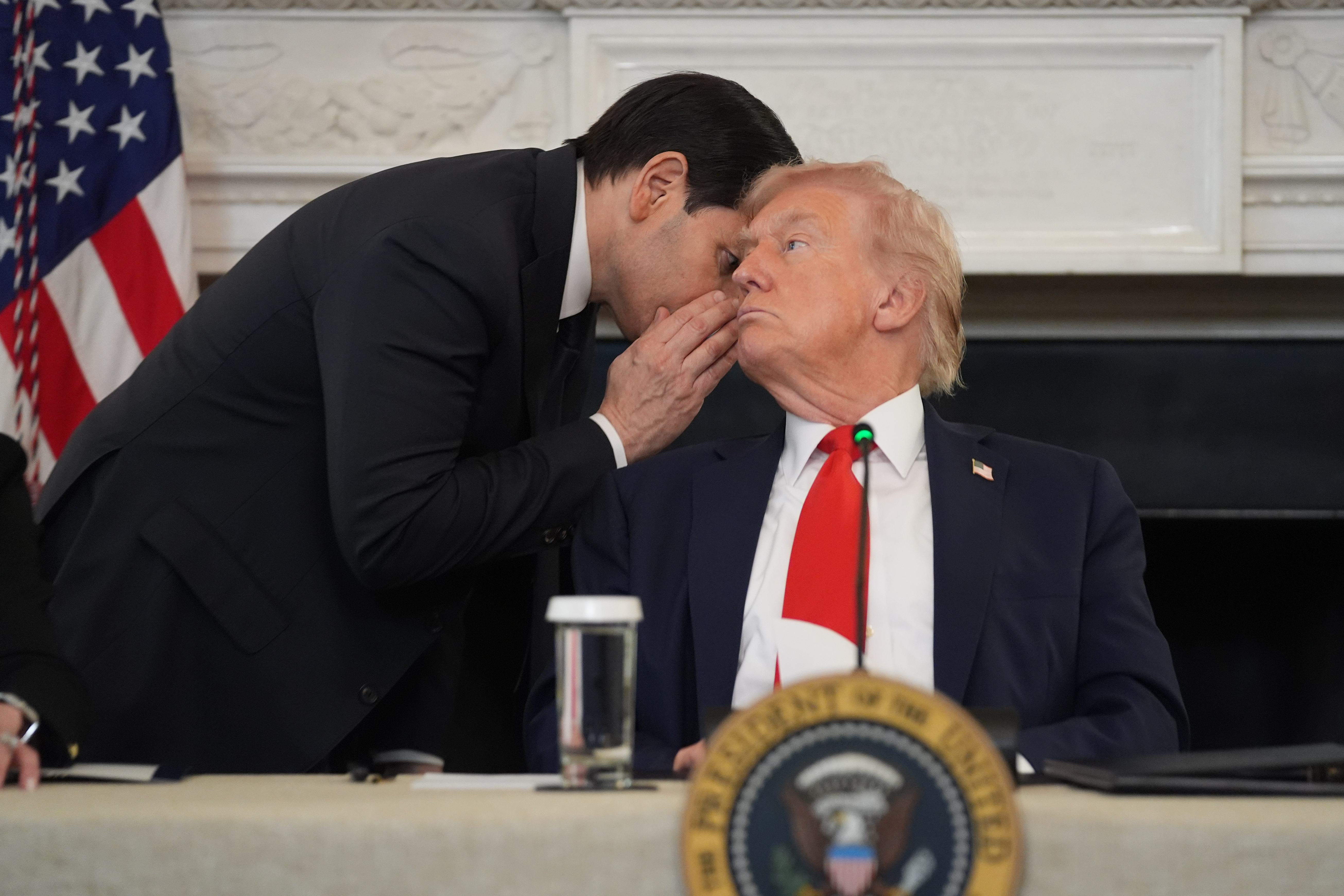 Marco Rubio whispers to Trump during an antifa roundtable