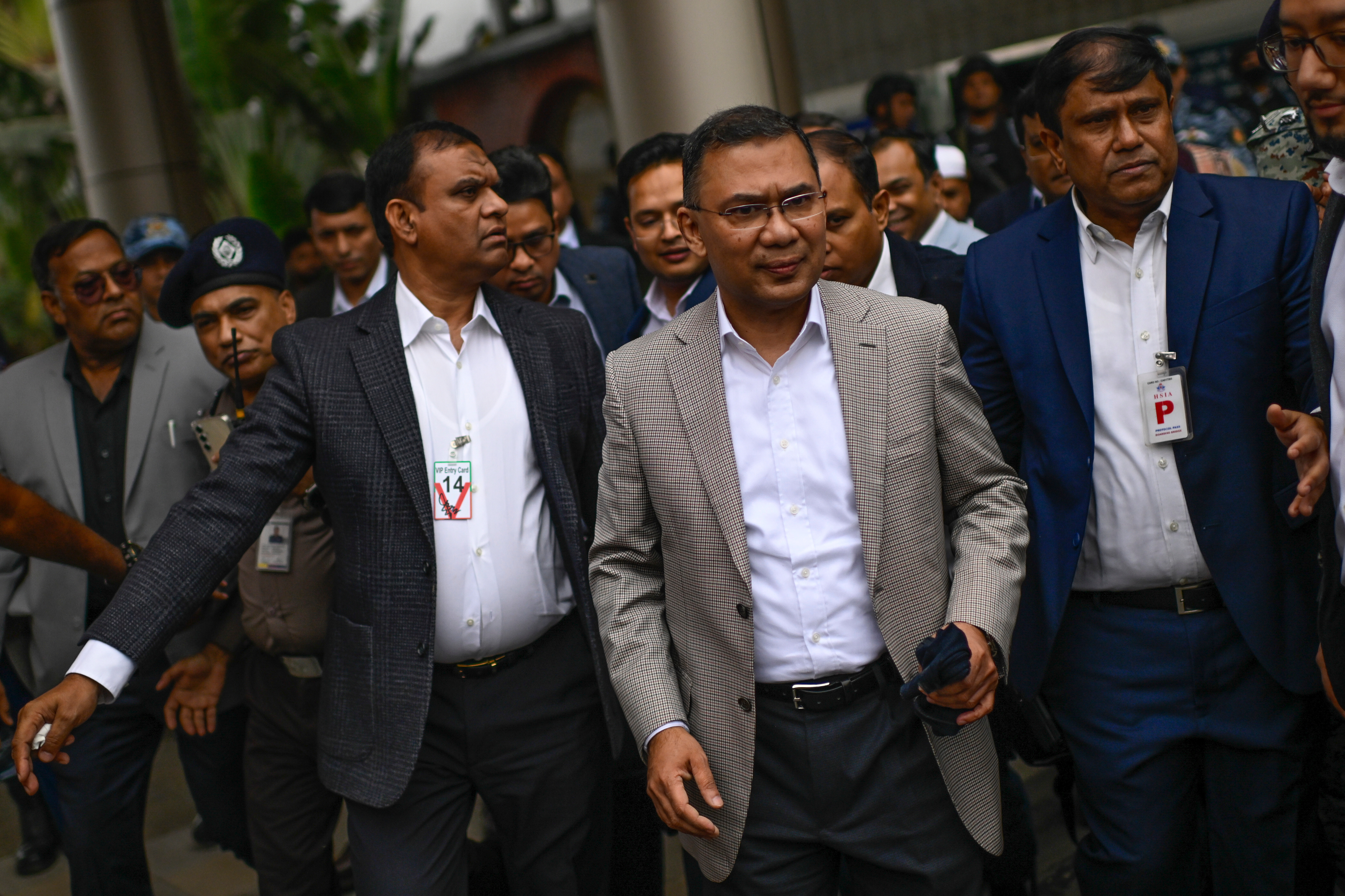 Bangladesh Nationalist Party (BNP) Acting Chairman, Tarique Rahman, center, arrives at Hazrat Shahjalal International Airport in Dhaka, Thursday, Dec. 25, 2025, after returning from London, ending more than 17 years of self-imposed exile. (AP Photo/Mahmud Hossain Opu)