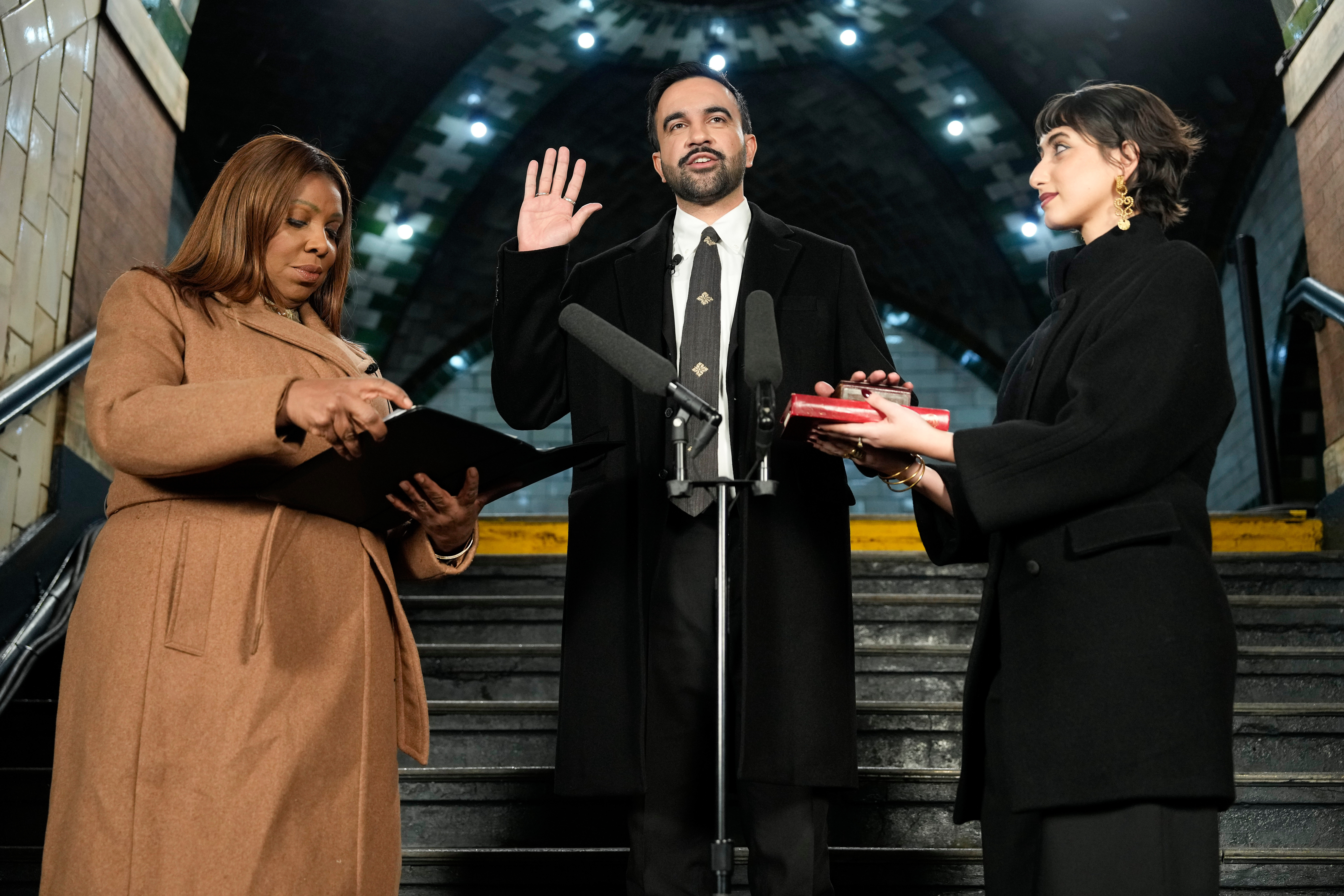 New York Attorney General Letitia James, left, administers the oath of office to mayor-elect Zohran Mamdani, center, as his wife Rama Duwaji looks on.