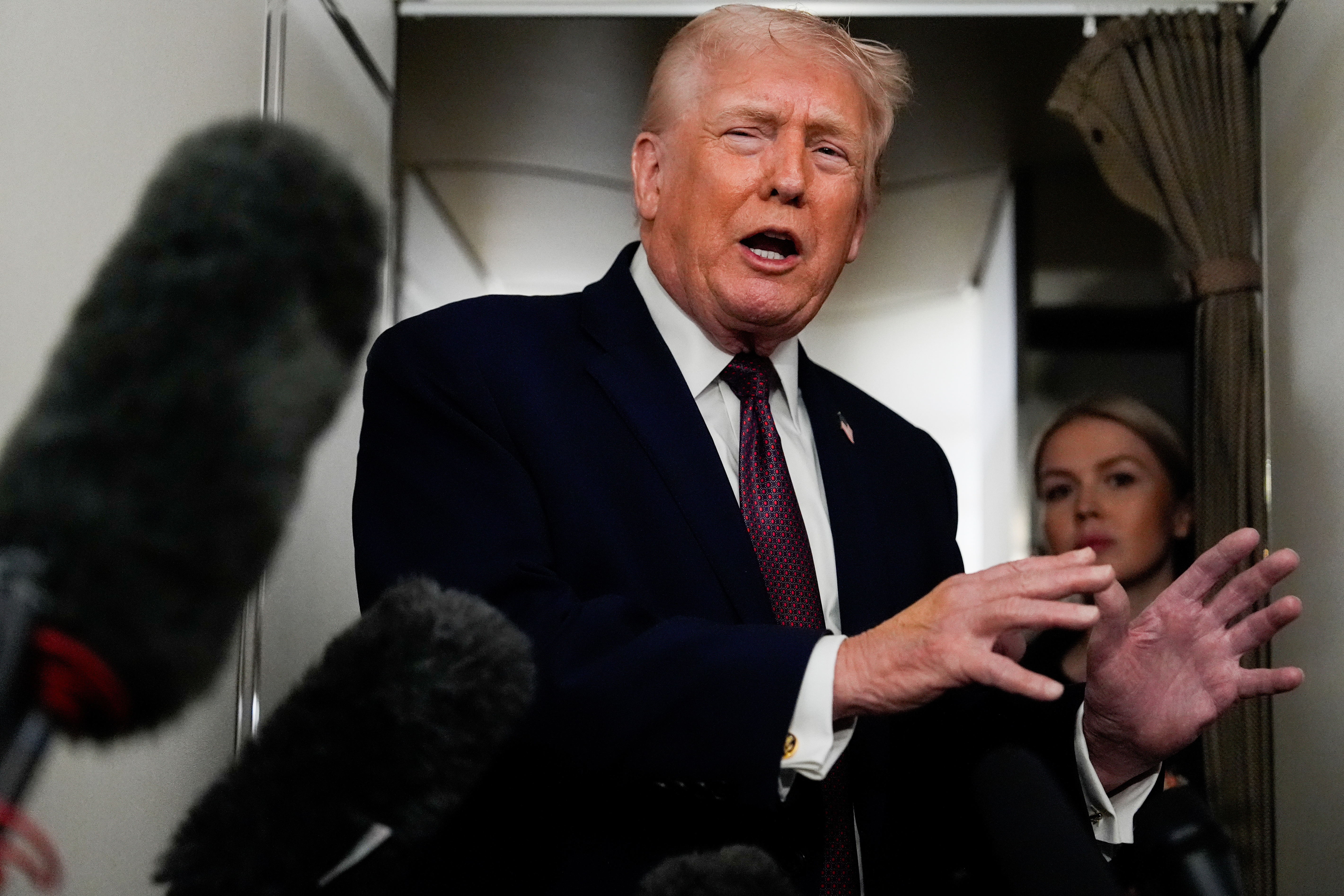 US President Donald Trump speaks to reporters on Air Force One on January 11, 2026
