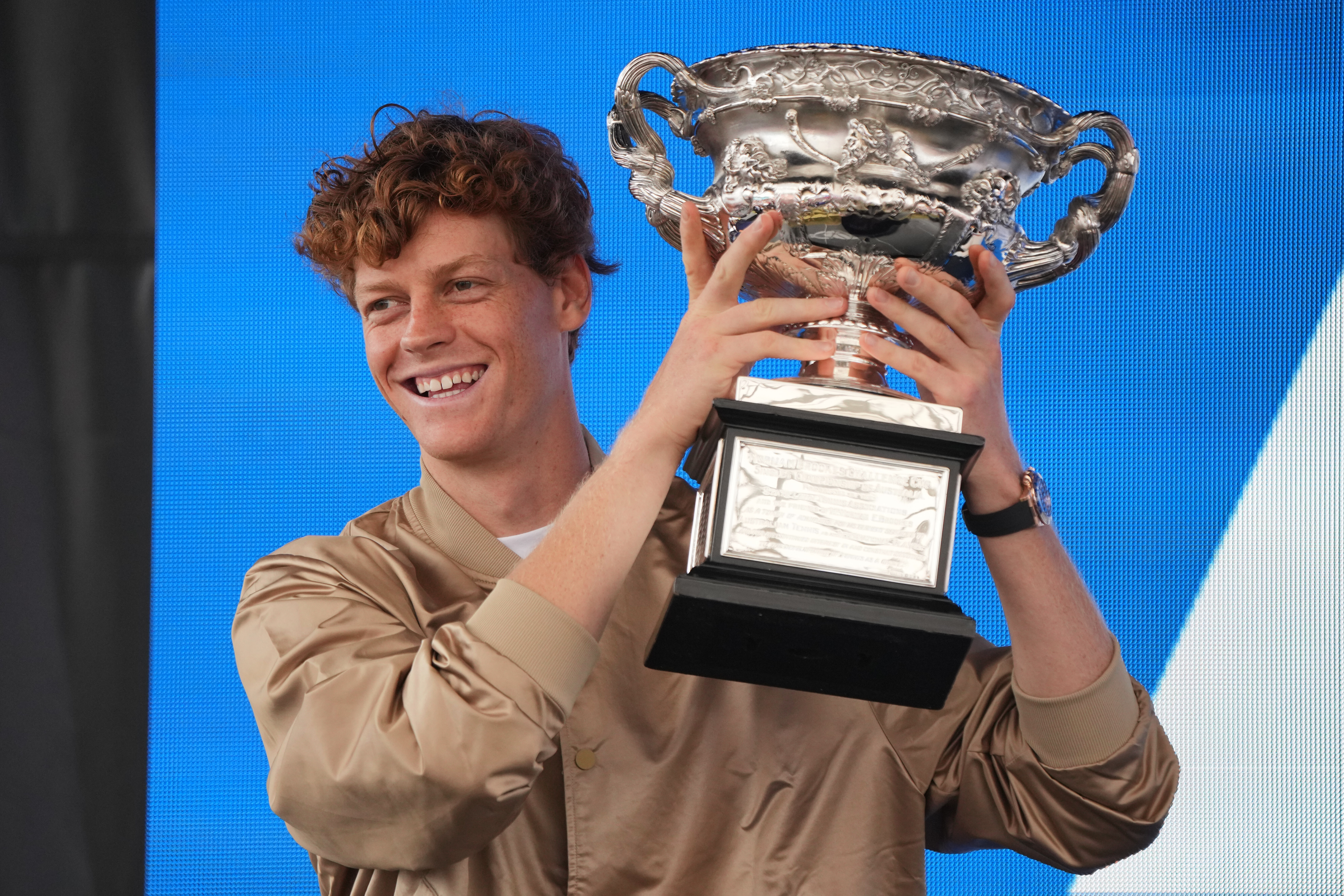 Men's defending singles champion, Jannik Sinner of Italy, holds his trophy, the Norman Brookes Challenge Cup, during the official draw ceremony ahead of the Australian Open tennis championship in Melbourne, Australia, Thursday, Jan. 15, 2026. (AP Photo/Dita Alangkara)