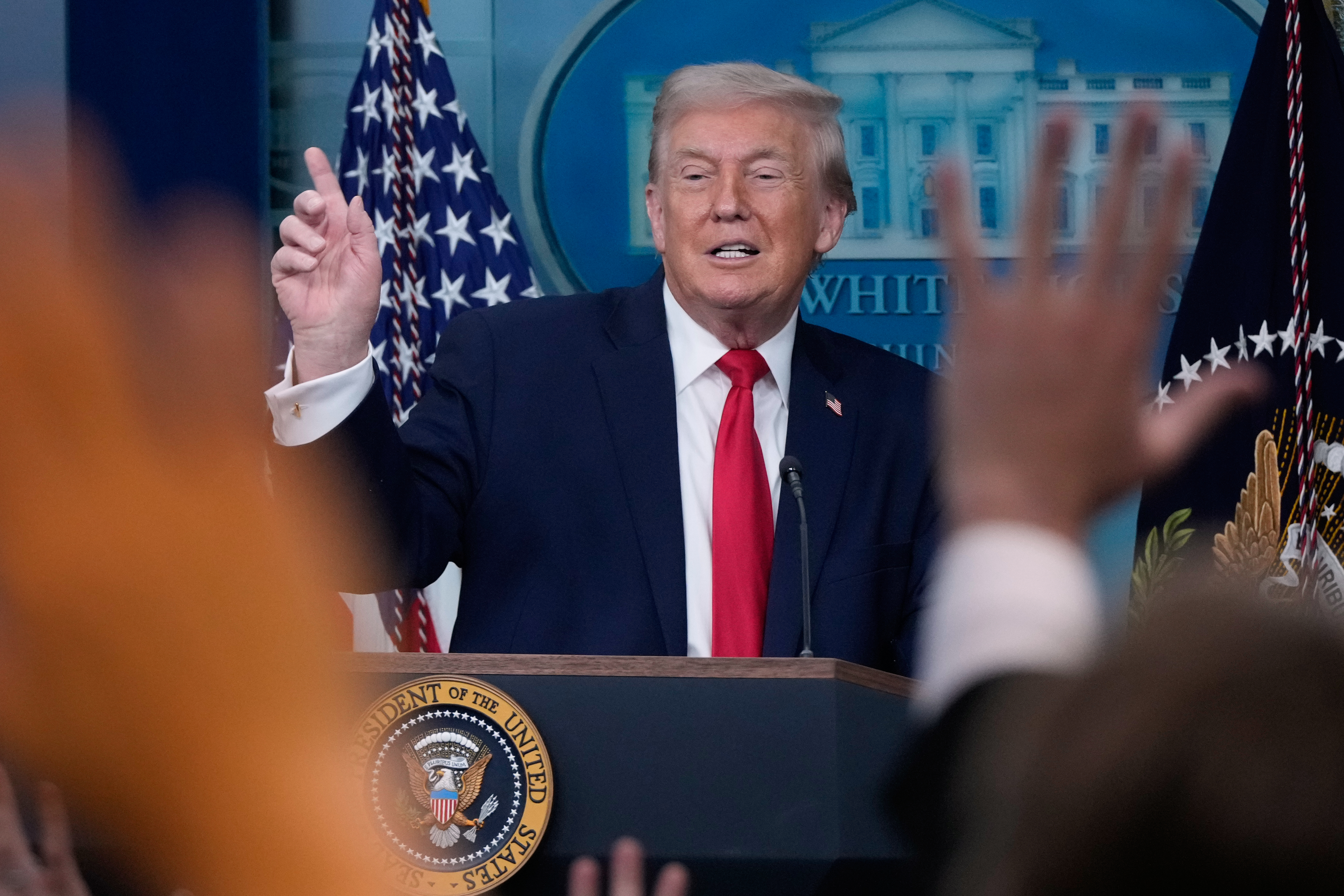 Trump takes questions from reporters at the White House