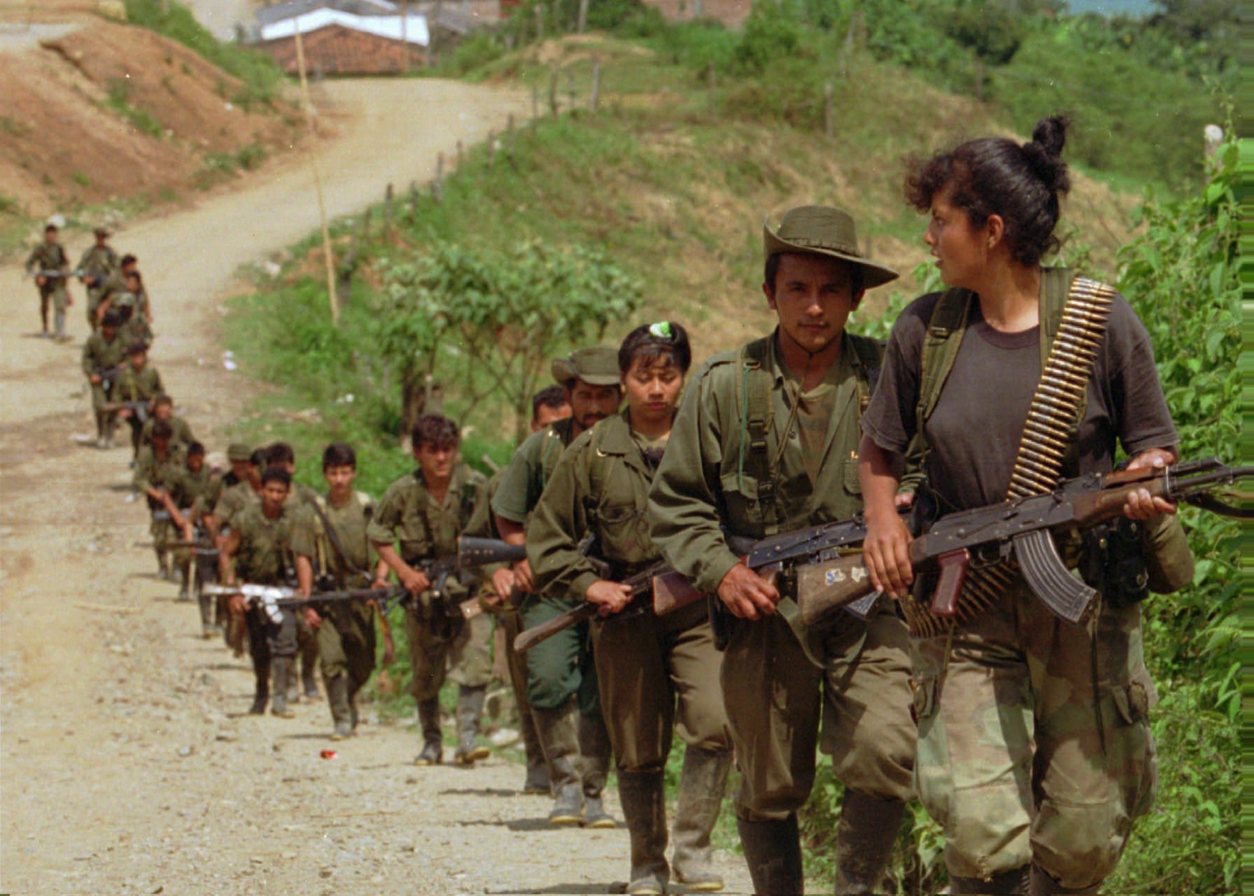 Rebels from the Revolutionary Armed Forces of Colombia (FARC), enter a small town near Miranda, Colombia, Wednesday, April 17, 1996. A column of the same rebel group ambushed a military convoy Monday killing 31 soldiers and wounding 18 outside the town of Puerres, located 350 miles southwest of Bogota. The FARC are the largest and oldest guerrilla group in Colombia. (AP Photo/Ricardo Mazalan)