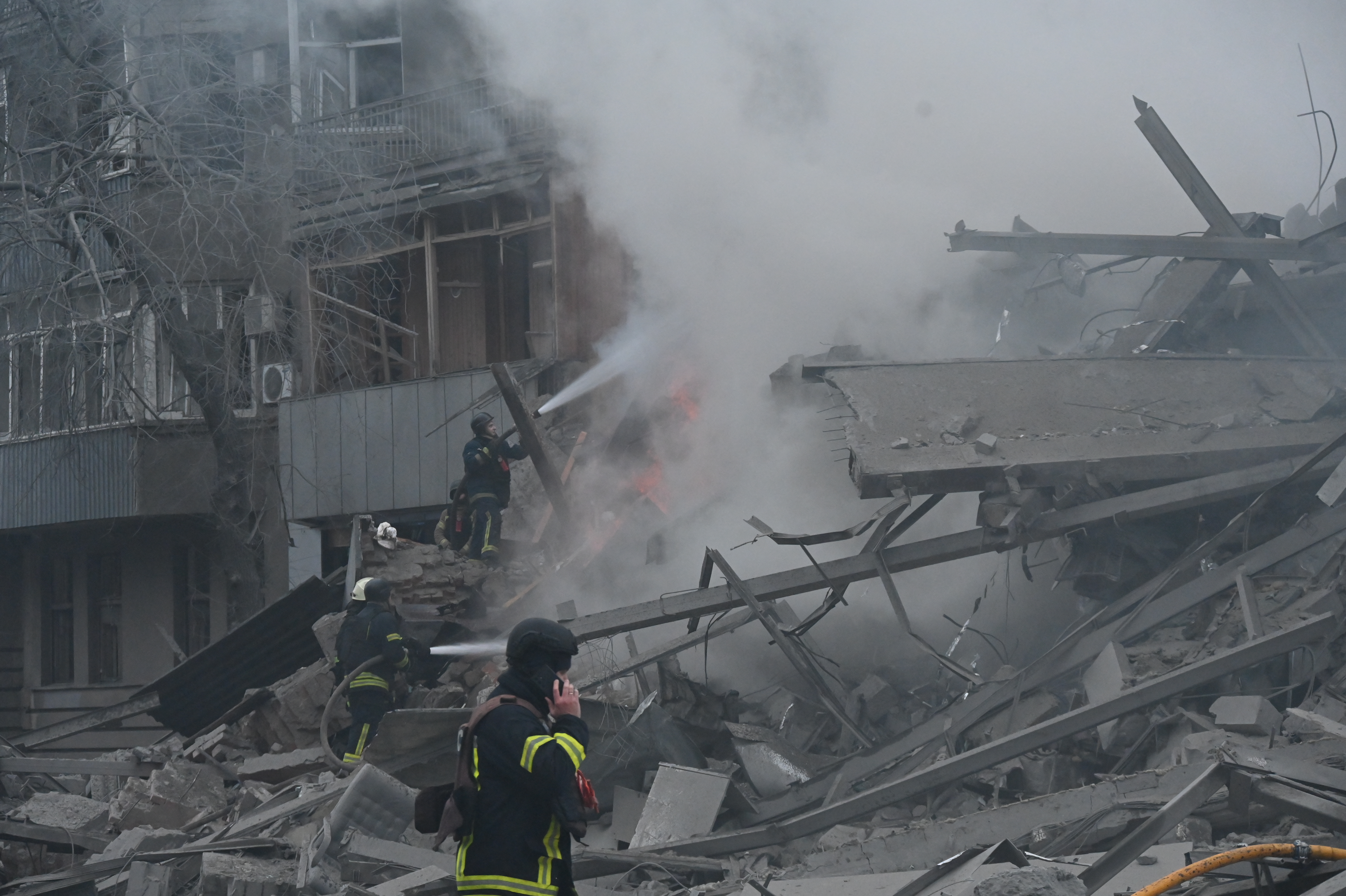 Ukrainian firefighters extinguish a fire in a residential building following a Russian air strike in Kharkiv on January 2, 2026, amid the Russian invasion of Ukraine. (Photo by SERGEY BOBOK / AFP)
