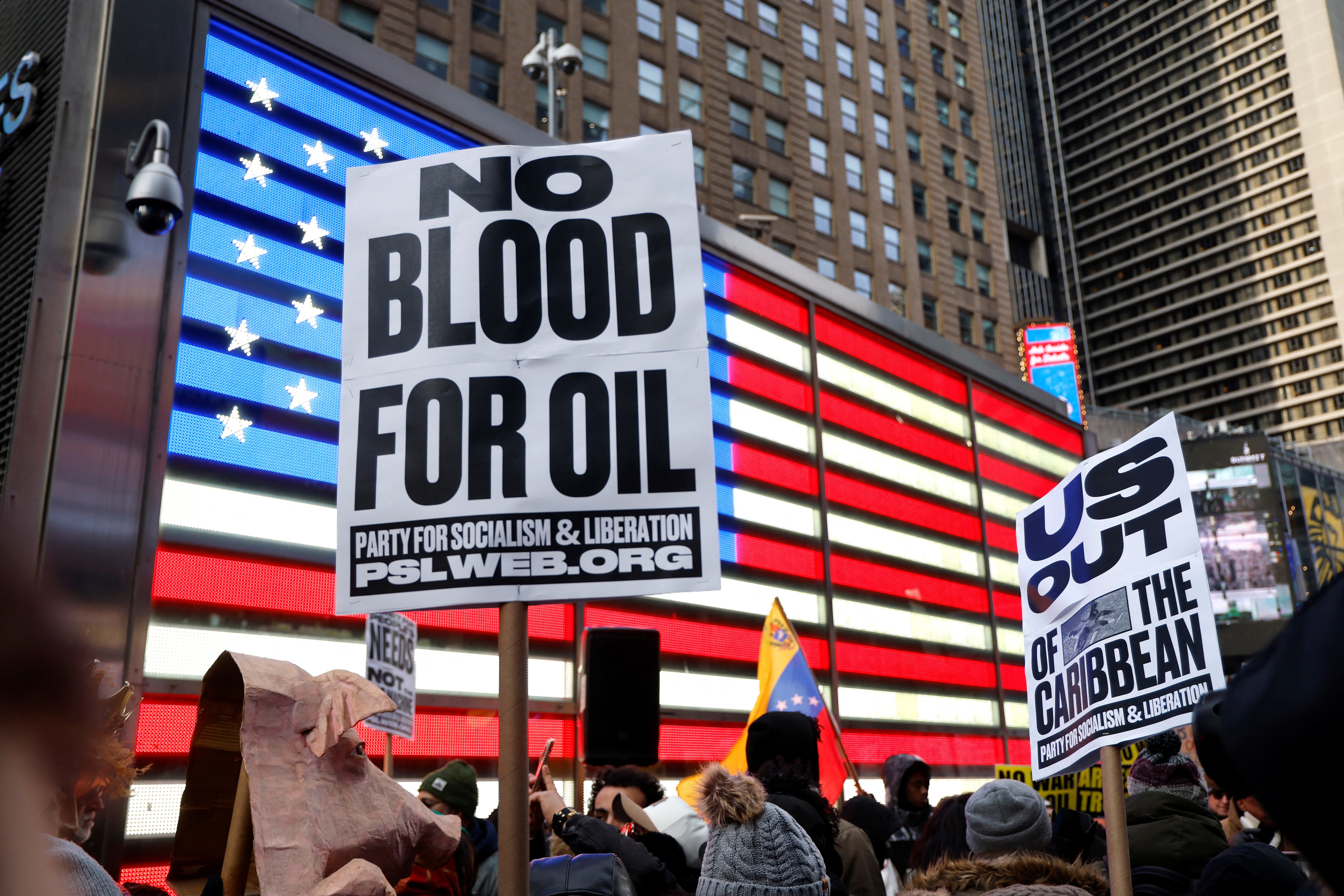People demonstrate against US military action in Venezuela in Times Square on January 3. 2026 in New York.