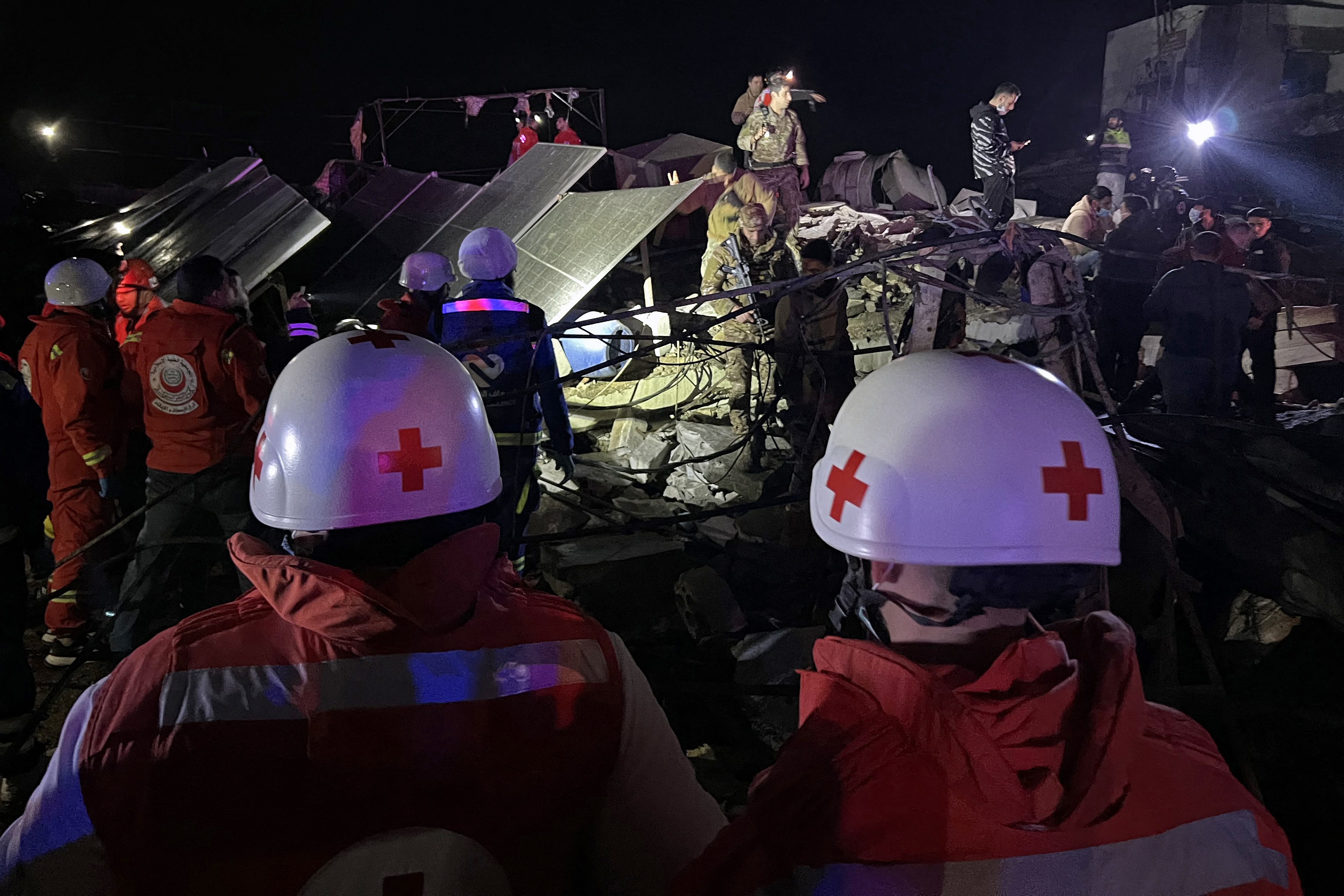 Rescuers, security personnel and members of civil defence inspect the site of a building that was destroyed by the Israeli strike in the industrial area of Ghazieh town, near the coastal city of Sidon, in southern Lebanon on January 6, 2026.