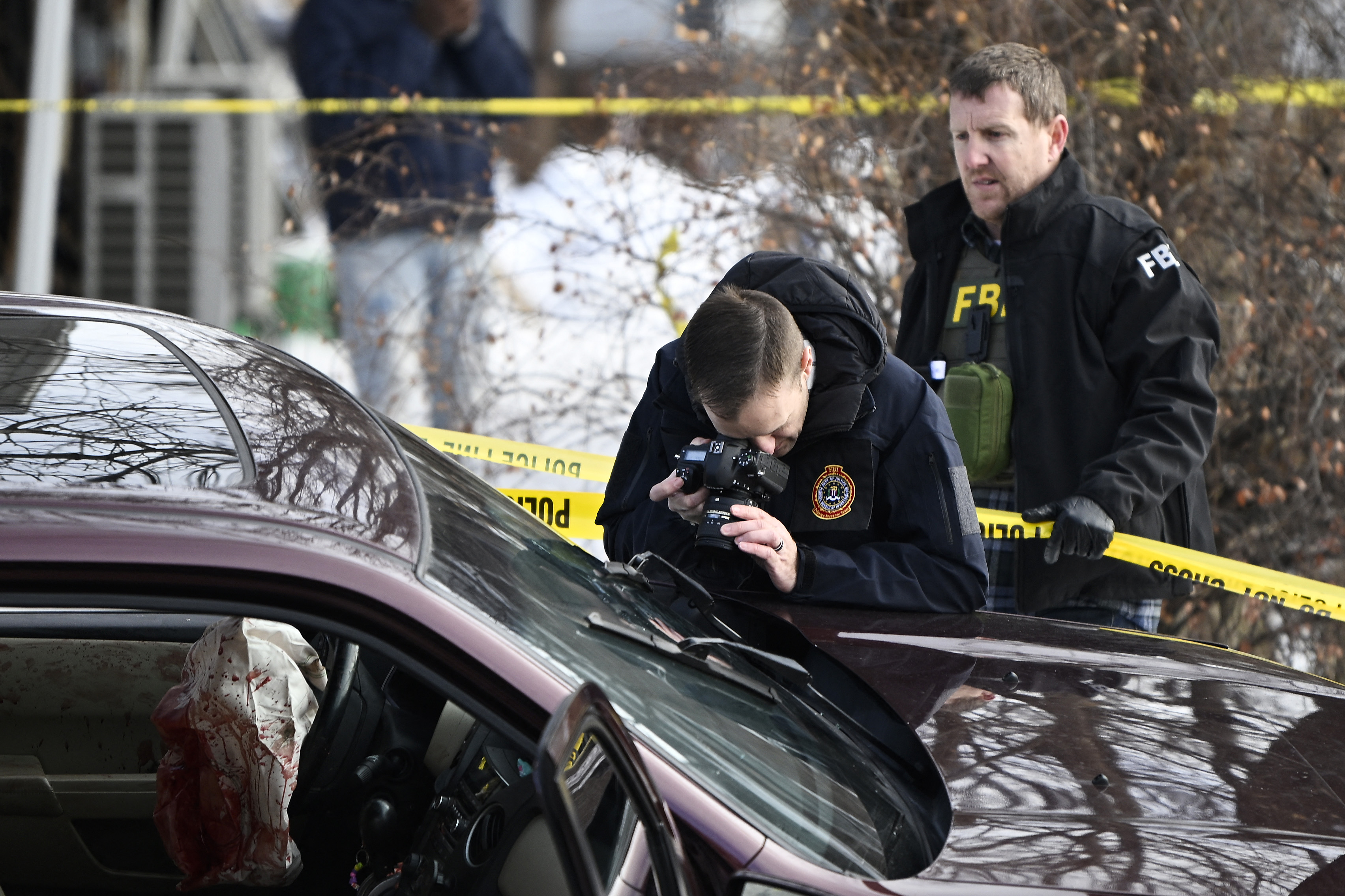 MINNEAPOLIS, MINNESOTA - JANUARY 07: Members of law enforcement photograph a vehicle suspected to be involved in a shooting by an ICE agent during federal law enforcement operations on January 07, 2026 in Minneapolis, Minnesota. According to federal officials, the agent, “fearing for his life” killed a woman during a confrontation in south Minneapolis. Stephen Maturen/Getty Images/AFP (Photo by Stephen Maturen / GETTY IMAGES NORTH AMERICA / Getty Images via AFP)