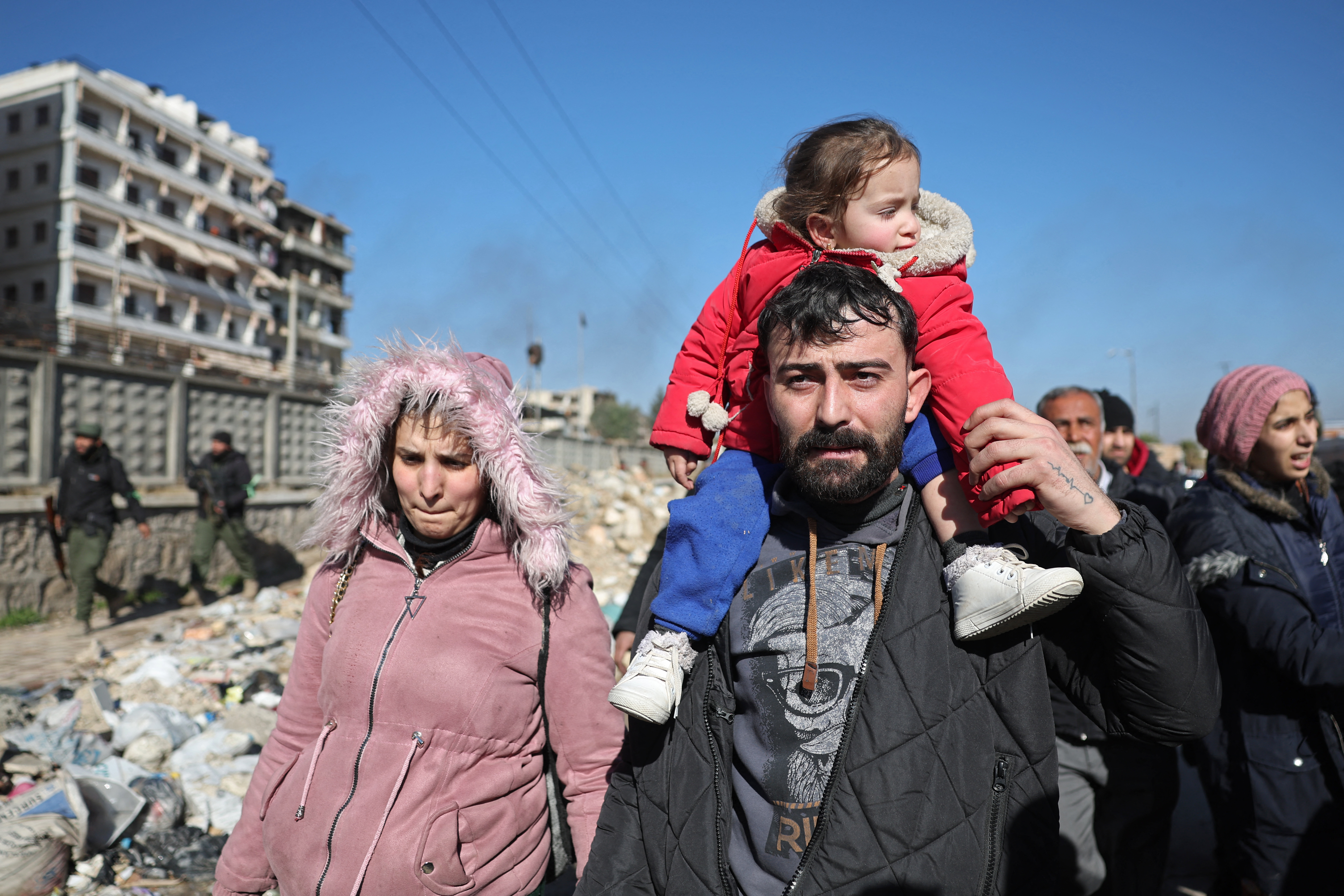 Residents of the Sheikh Maqsud neighbourhood are escorted out of the harms way by the members of Syrian government security forces, in Aleppo on January 10, 2026, following their clashes with Kurdish forces.