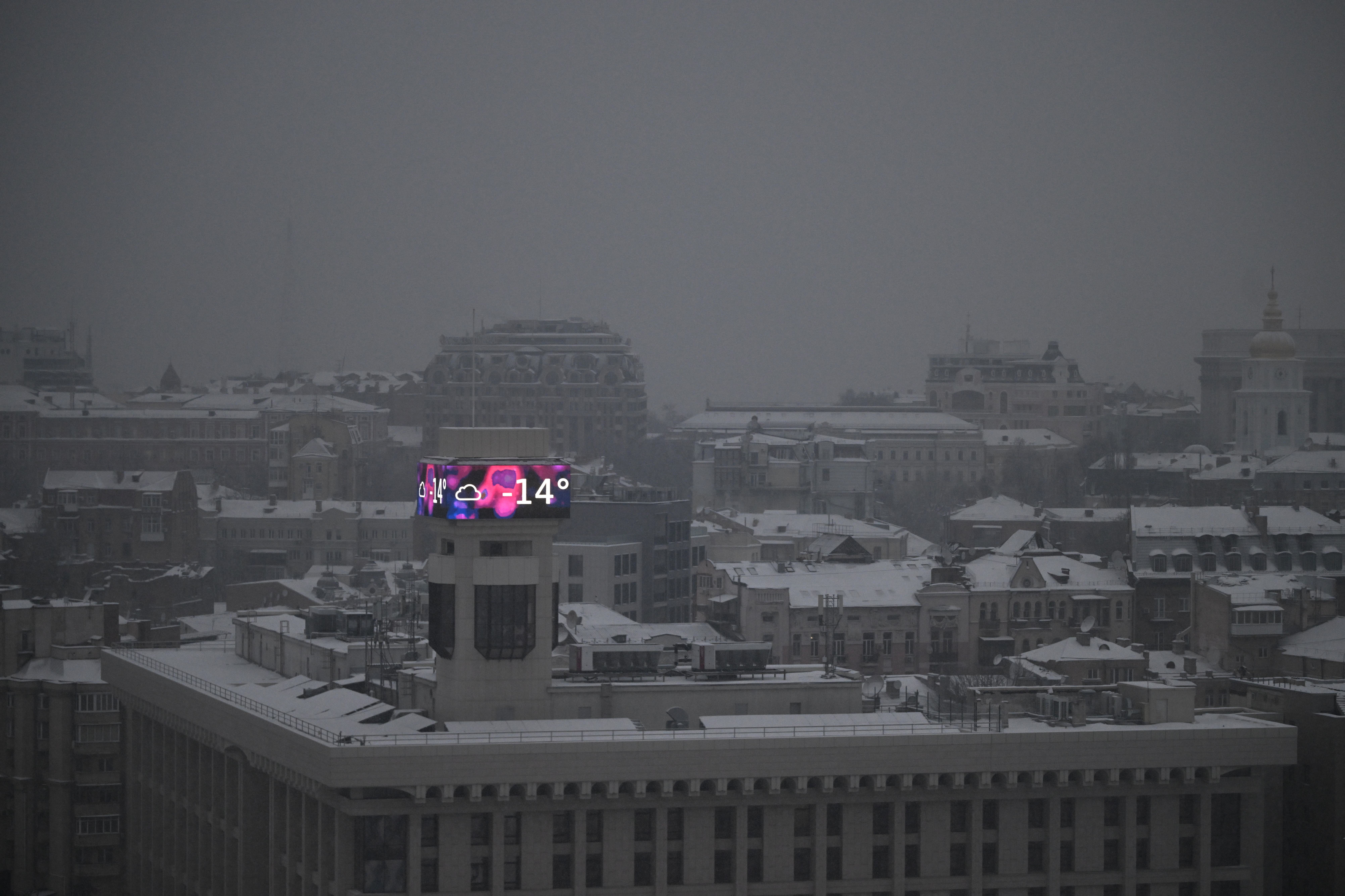 TOPSHOT - This photograph shows a big screen on a building displaying a temperature of -14 degrees Celsius in Kyiv on January 14, 2026, amid the Russian invasion of Ukraine.