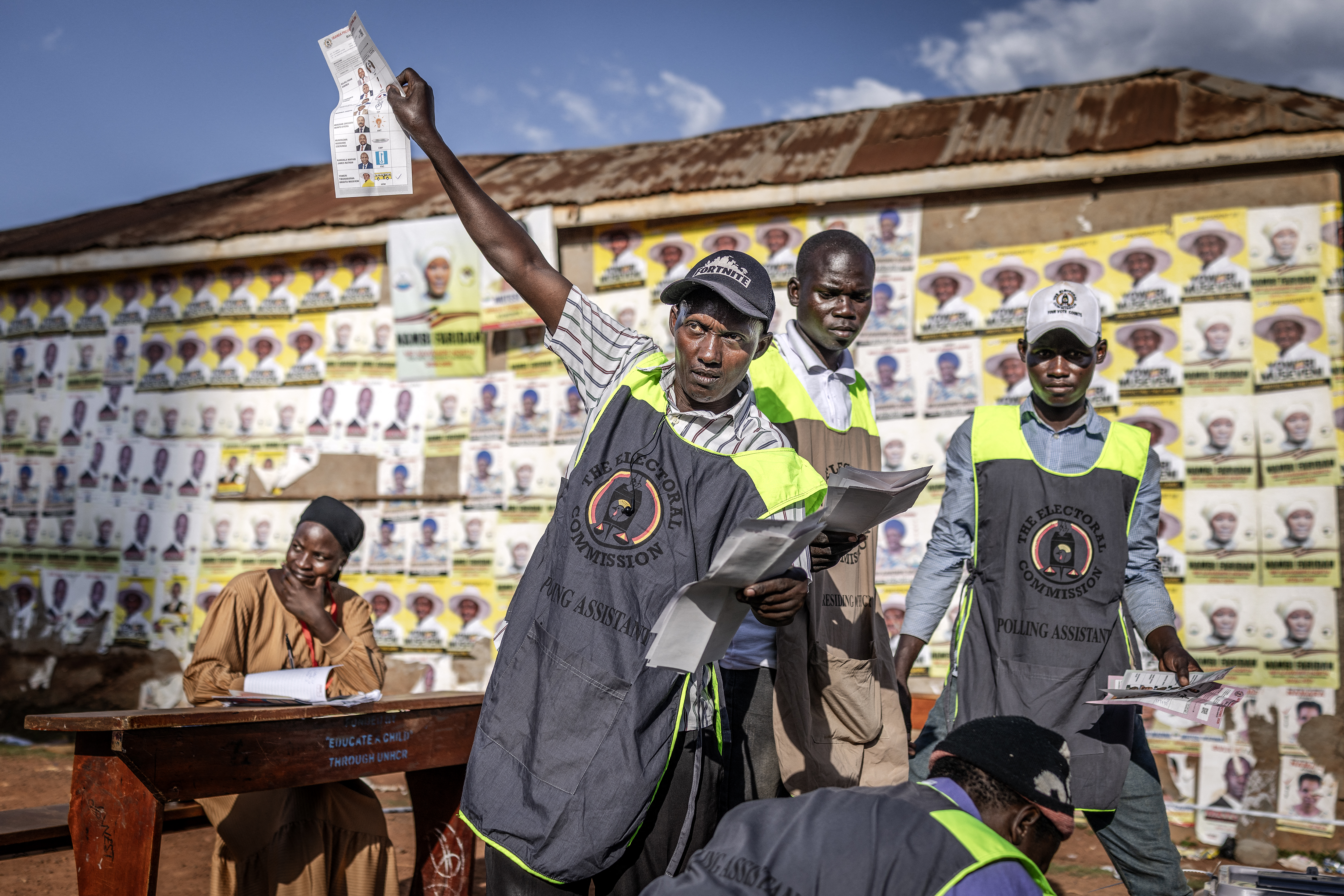 A polling assistant from Uganda’s Electoral Commission counts votes after the closing of the polls at a public ground used as a polling station in Kampala on January 15, 2026, during Uganda’s 2026 general elections. (Photo by Luis TATO / AFP)