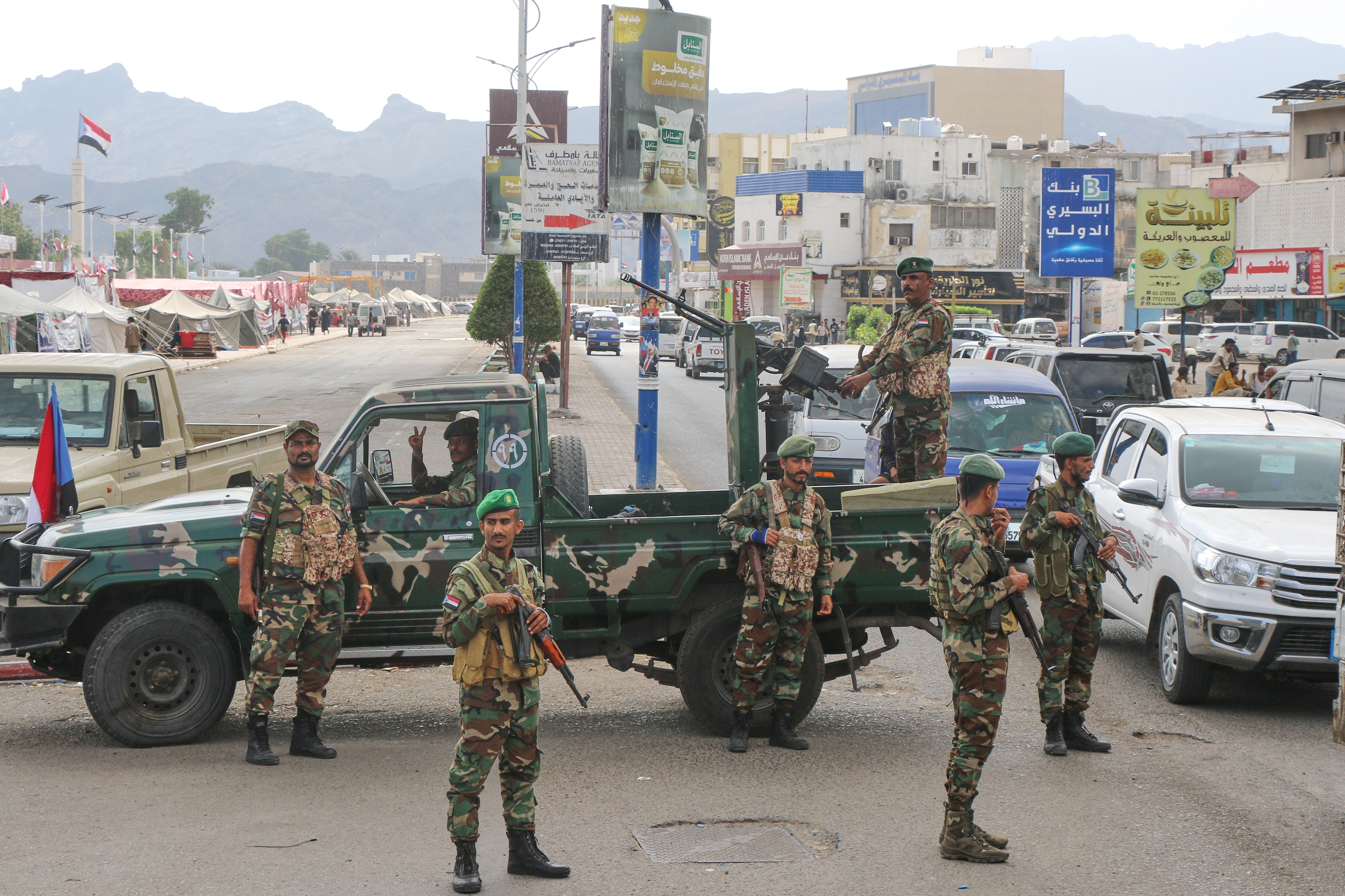 Southern Yemen soldiers of Southern Transitional Council (STC) stand with their guns at a checkpoint.