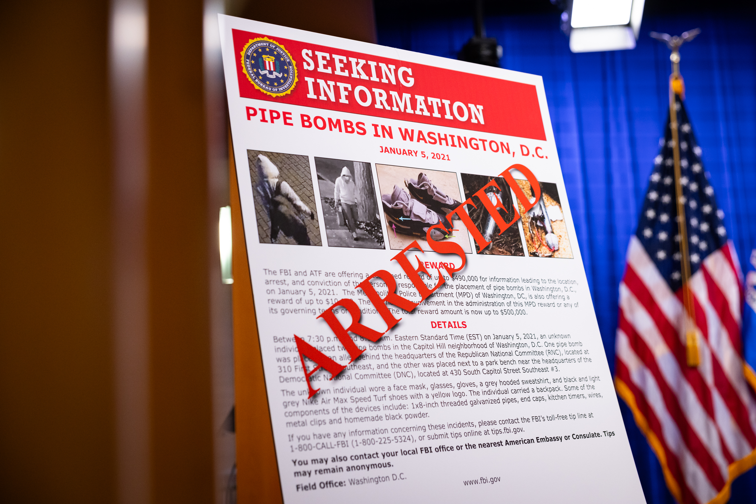 epa12570536 A sign for depicting the arrested suspect is seen before a press conference at the Department of Justice in Washington, DC, USA, 04 December 2025. Federal officials have arrested a man who allegedly planted pipe bombs at the Democratic and Republication national committee headquarters the night before the January 6th riots at the US Capitol. EPA/MAANSI SRIVASTAVA