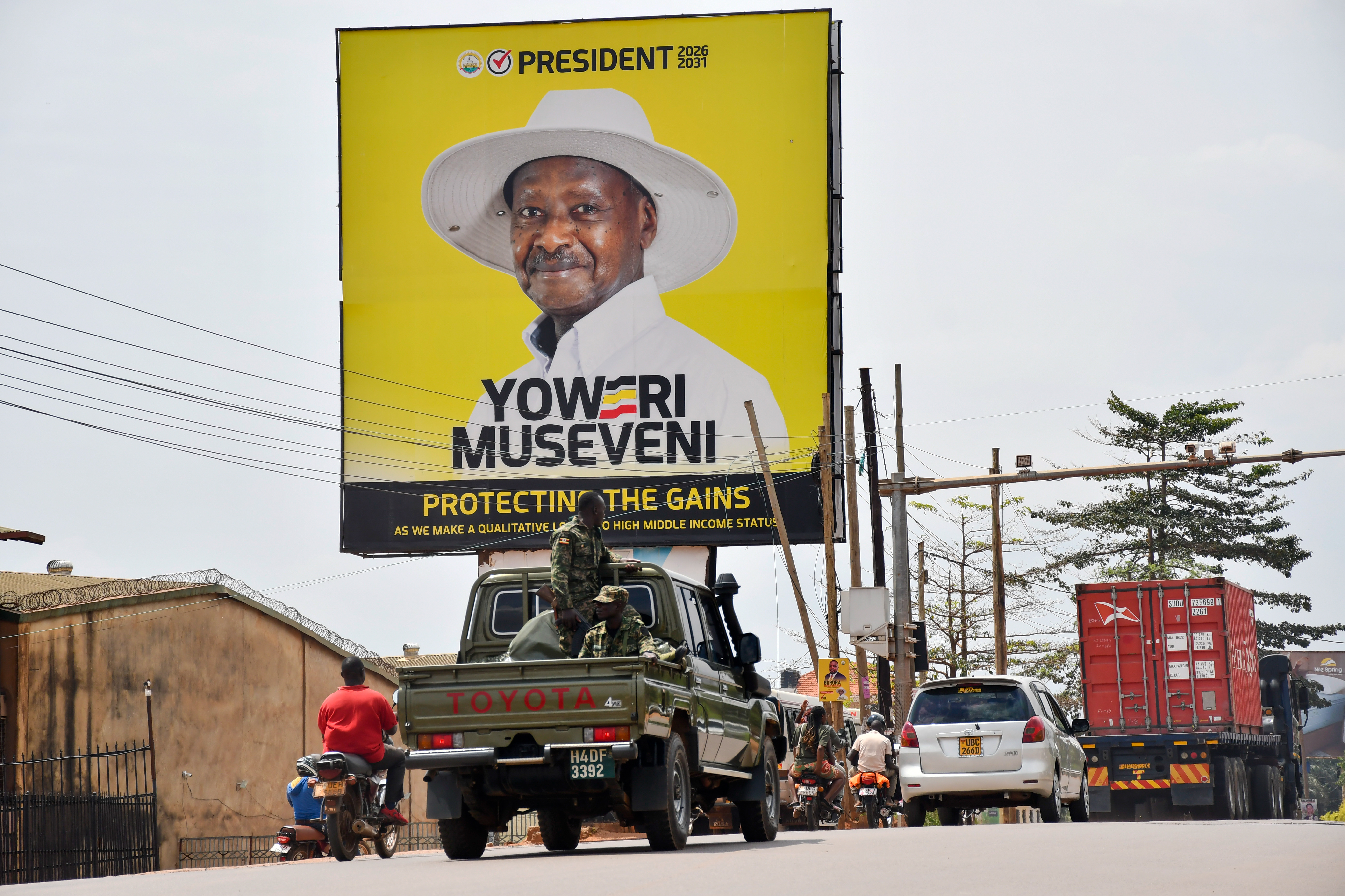 epa12646494 Motorists drive past an electoral billboard showing incumbent President and National Resistance Movement (NRM) presidential candidate Yoweri Museveni in Kampala, Uganda, 13 January 2026. Eight presidential candidates, including Museveni and NUP candidate Bobi Wine, are vying for the presidency in Uganda, scheduled for 15 January. Museveni seeks a seventh term after four decades in power. EPA/ISAAC KASAMANI
