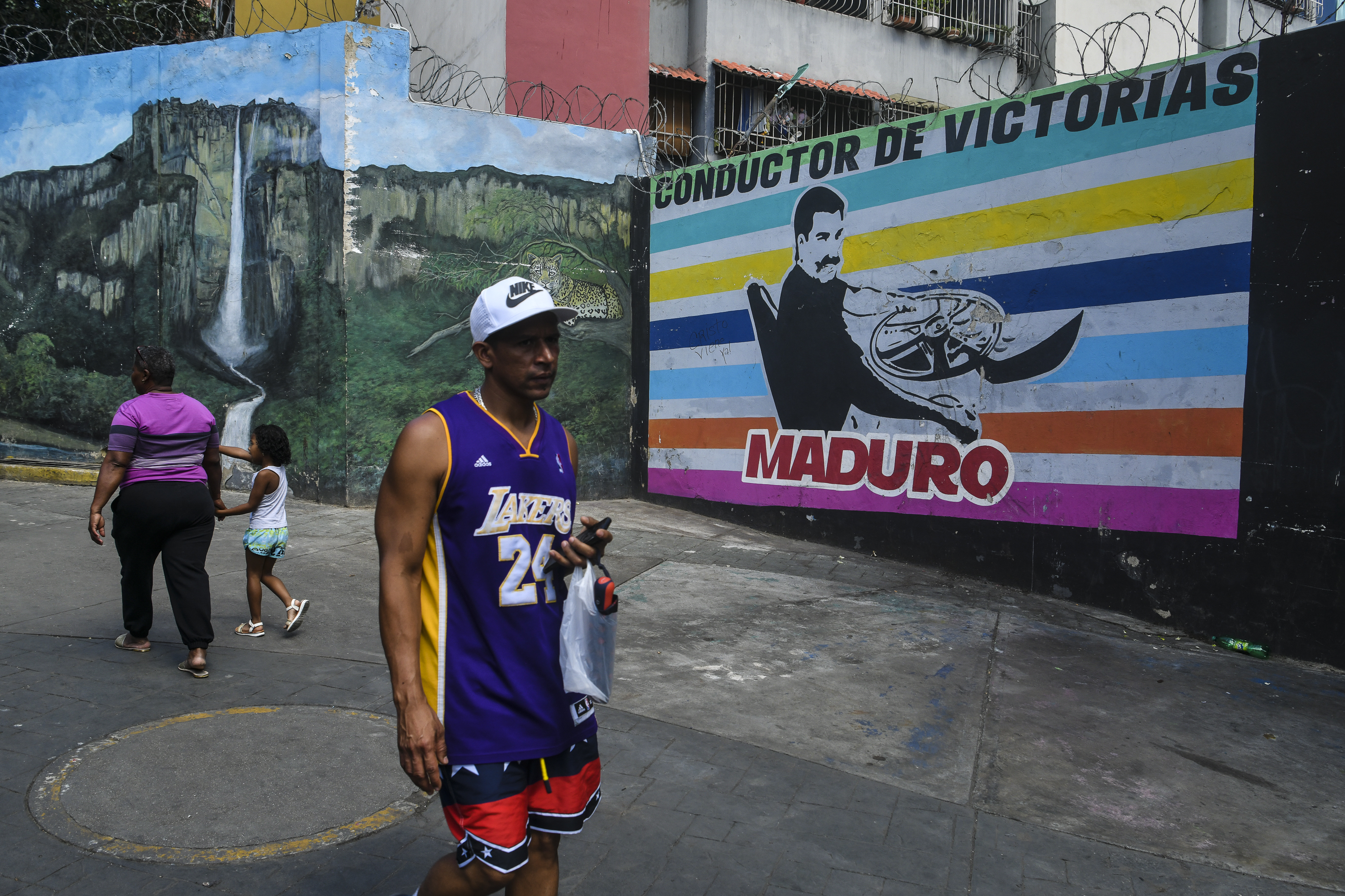 CARACAS, VENEZUELA - JANUARY 8: CARACAS, VENEZUELA - JANUARY 8: People walk past a mural depicting former Venezuelan President Nicolás Maduro on January 8, 2026, in Caracas, Venezuela. On January 3, U.S. President Donald Trump announced that the United States had launched a large-scale military operation in Venezuela, resulting in the capture of Maduro and his wife, Cilia Flores. Both were flown to New York, where they are being held and await a federal court appearance scheduled for March 17 on criminal charges. (Photo by Carlos Becerra/Getty Images)