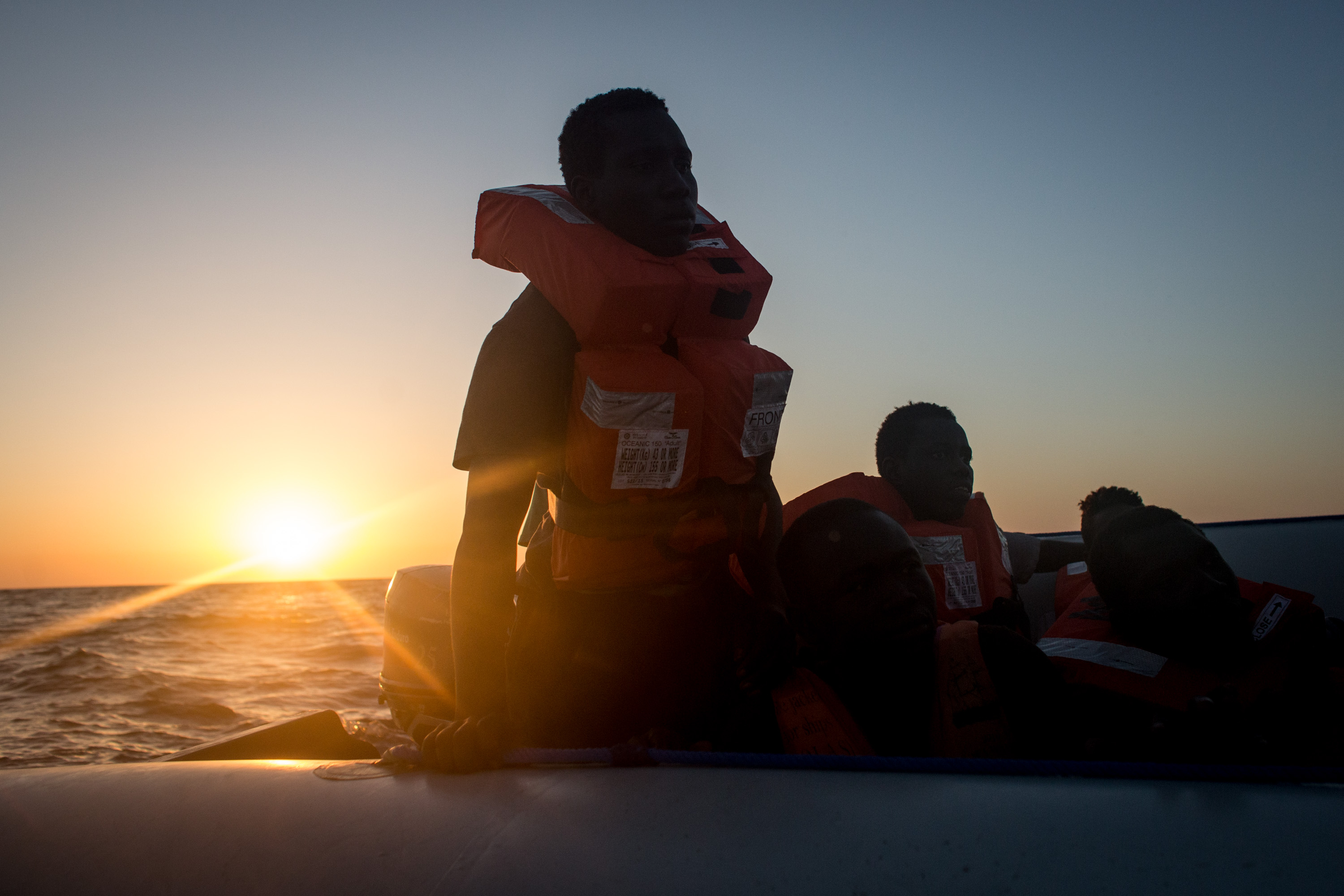 LAMPEDUSA, ITALY - JUNE 10: Refugees and migrants wait in a small rubber boat to be rescued by crewmembers from the Migrant Offshore Aid Station (MOAS) Phoenix vessel on June 10, 2017 off Lampedusa, Italy. An estimated 230,000 refugees and migrants will arrive in Italy this year as numbers of refugees and migrants attempting the dangerous central mediterranean crossing from Libya to Italy continues to rise since the same time last year. So far this year more than 58,000 people have arrived in Italy and 1,569 people have died attempting the crossing. Libya continues to be the primary departure point for refugees and migrants taking the central mediterranean route to Sicily. In an attempt to slow the flow of migrants, Italy recently signed a deal with Libya, Chad and Niger outlining a plan to increase border controls and add new reception centers in the African nations, which are key transit points for migrants heading to Italy. MOAS is a Malta based NGO dedicated to providing professional search-and-rescue assistance to refugees and migrants in distress at sea. Since the start of the year MOAS have rescued and assisted more than 4000 people and are currently patrolling and running rescue operations in international waters off the coast of Libya. (Photo by Chris McGrath/Getty Images)