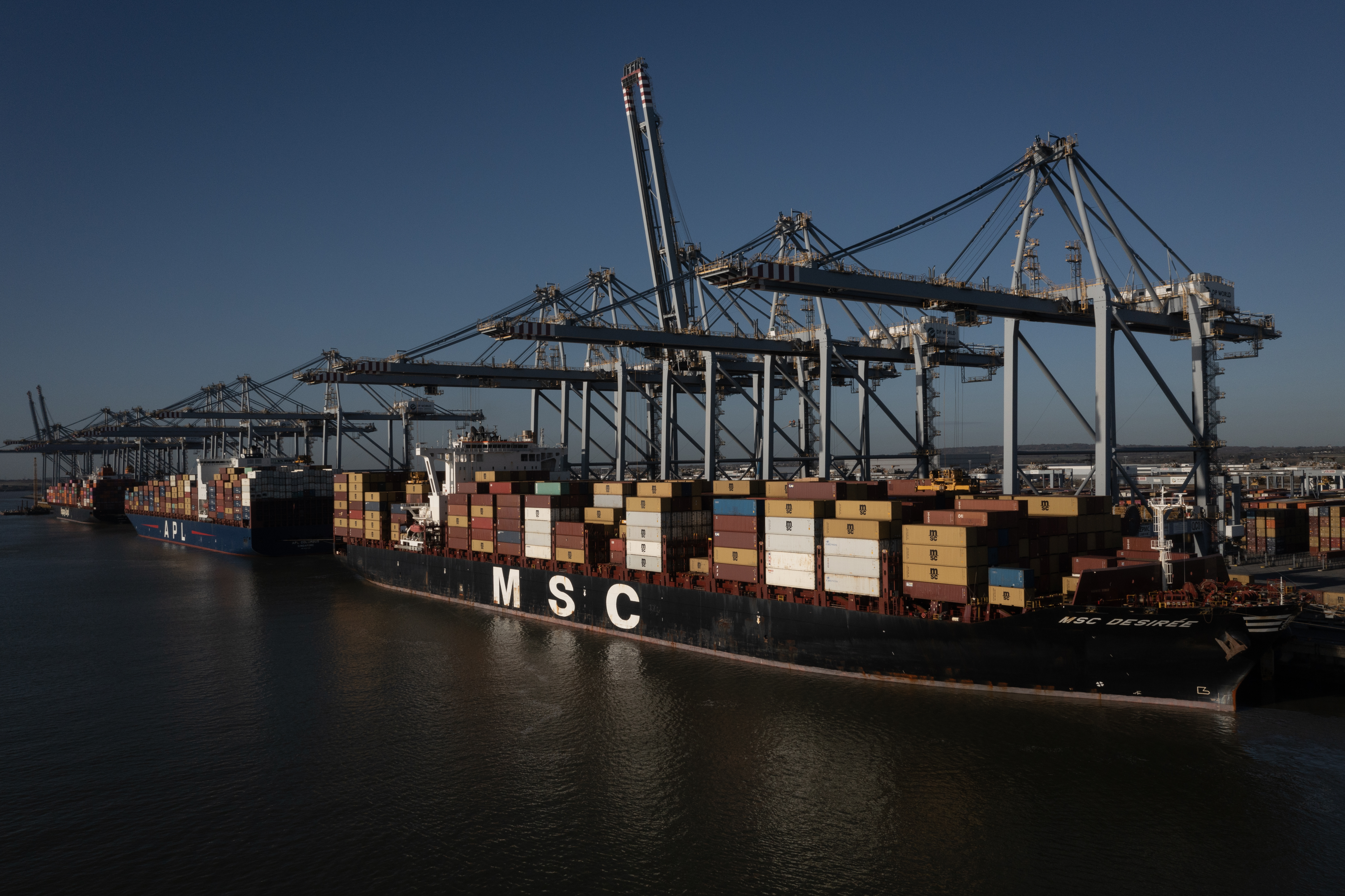 STANFORD-LE-HOPE, ENGLAND - NOVEMBER 26: Shipping containers are loaded onto an M.S.C container ship at London Gateway port, operated by DP World Plc on November 26, 2024 in Stanford-le-Hope, England. DP World, owner and operator of the London Gateway deep water port, has launched operations of an all-electric fourth berth, expanding the port's capacity and creating 200 permanent jobs. In October, DP World confirmed a £1 billion investment plan into expanding the logistics hub on the Thames River with the development of an additional two berths, which would make London Gateway Britain's largest container port within the next five years. (Photo by Dan Kitwood/Getty Images)