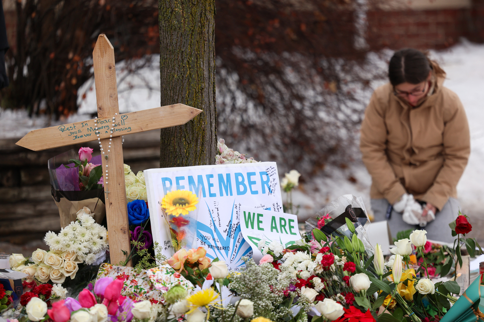 People gather at a makeshift memorial for 37-year-old Renee Nicole Good, who was shot and killed at point blank range on January 7 by a US Immigration and Customs Enforcement (ICE) agent as she apparently tried to drive away from agents who were crowding around her car, in Minneapolis, Minnesota, on Jan. 8, 2026. [Charly Triballeau/AFP]