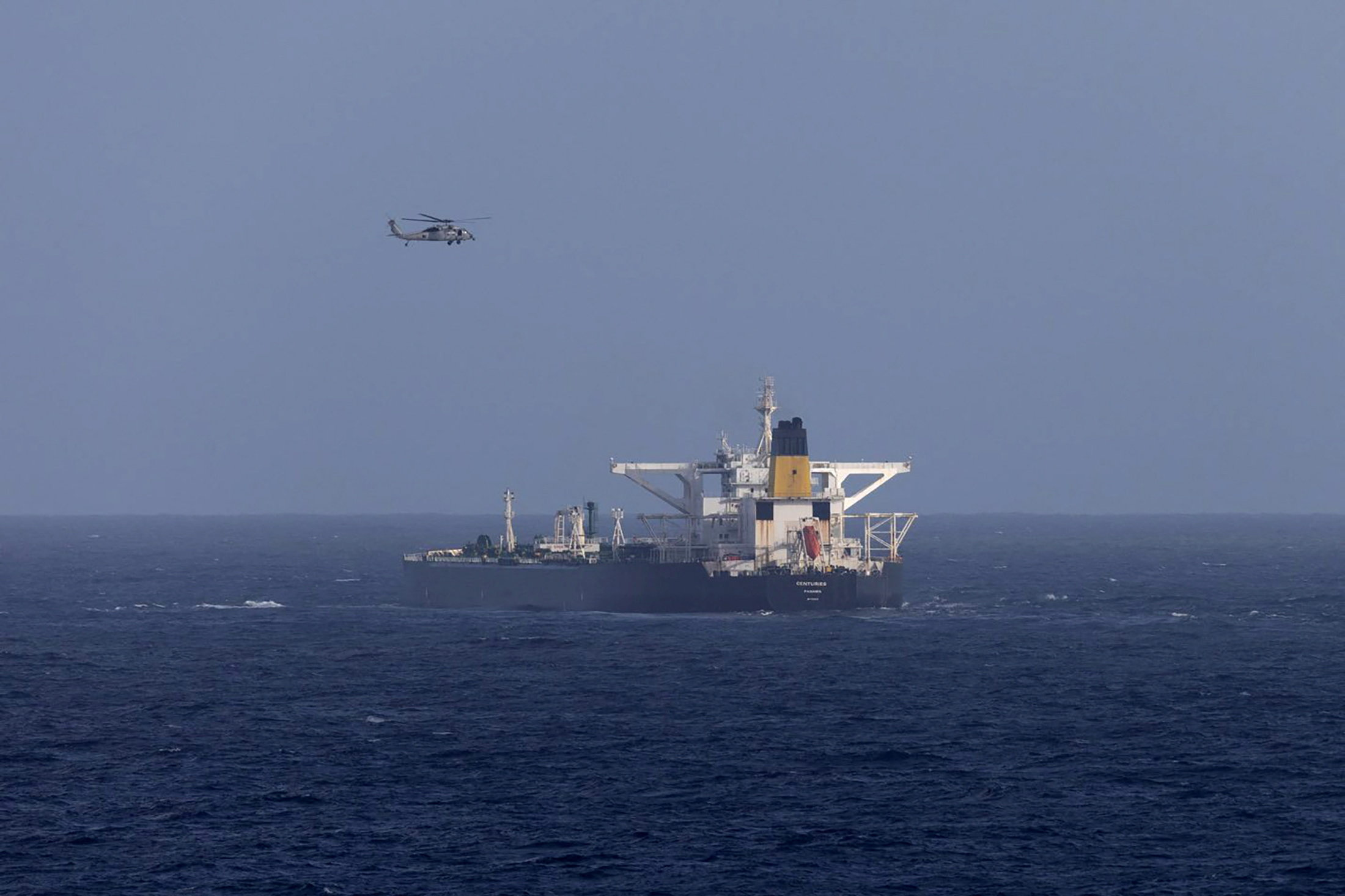 A U.S. military helicopter flies over the Panama-flagged Centuries, which was intercepted by the U.S. Coast Guard, days after U.S. President Donald Trump announced a "blockade" of all sanctioned oil tankers entering and leaving Venezuela, east of Barbados in the Caribbean Sea December 20, 2025. DHS/Handout via REUTERS THIS IMAGE HAS BEEN SUPPLIED BY A THIRD PARTY