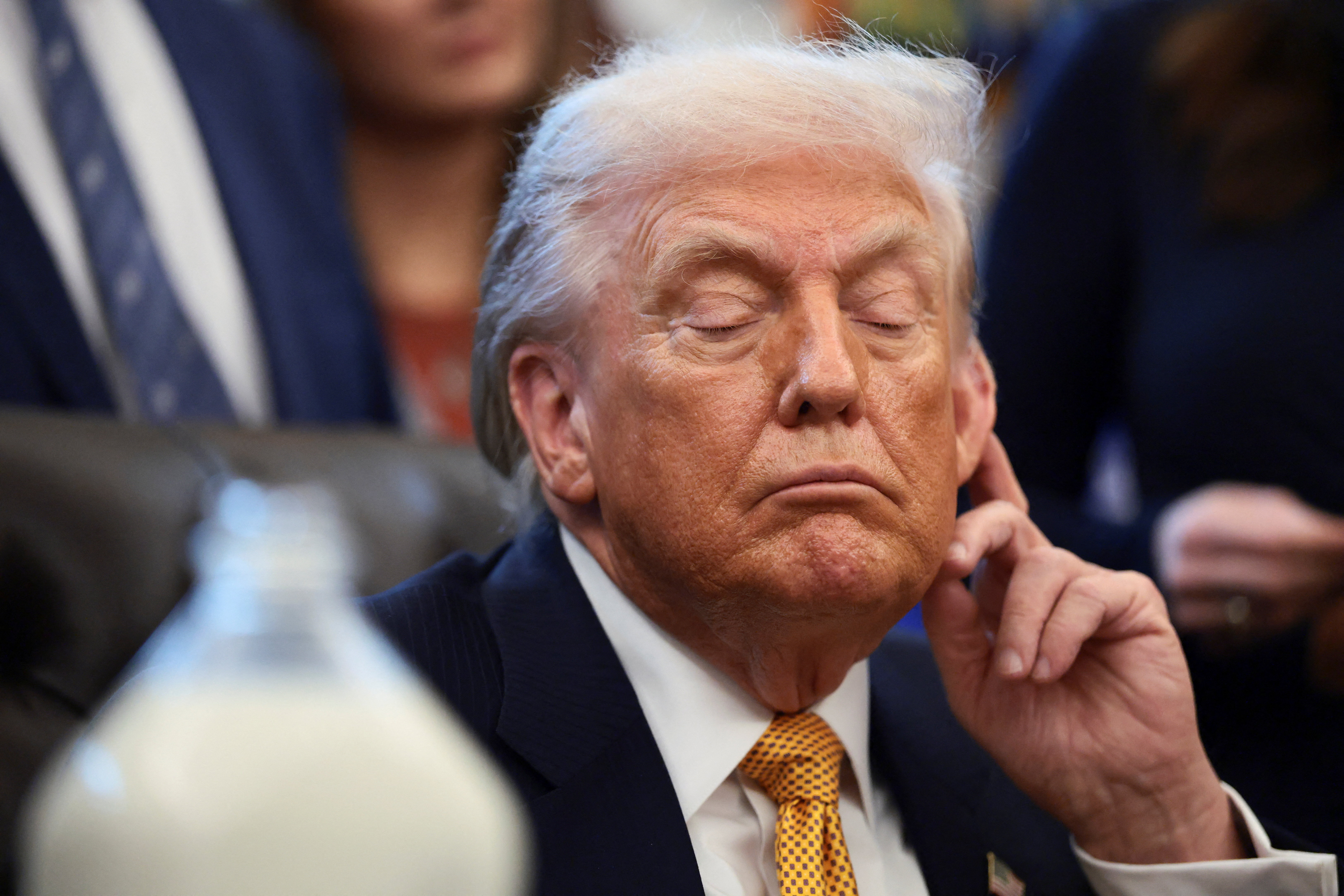 U.S. President Donald Trump listens during a signing ceremony for the Whole Milk for Healthy Kids Act in the Oval Office at the White House in Washington, D.C., U.S., January 14, 2026. REUTERS/Evelyn Hockstein