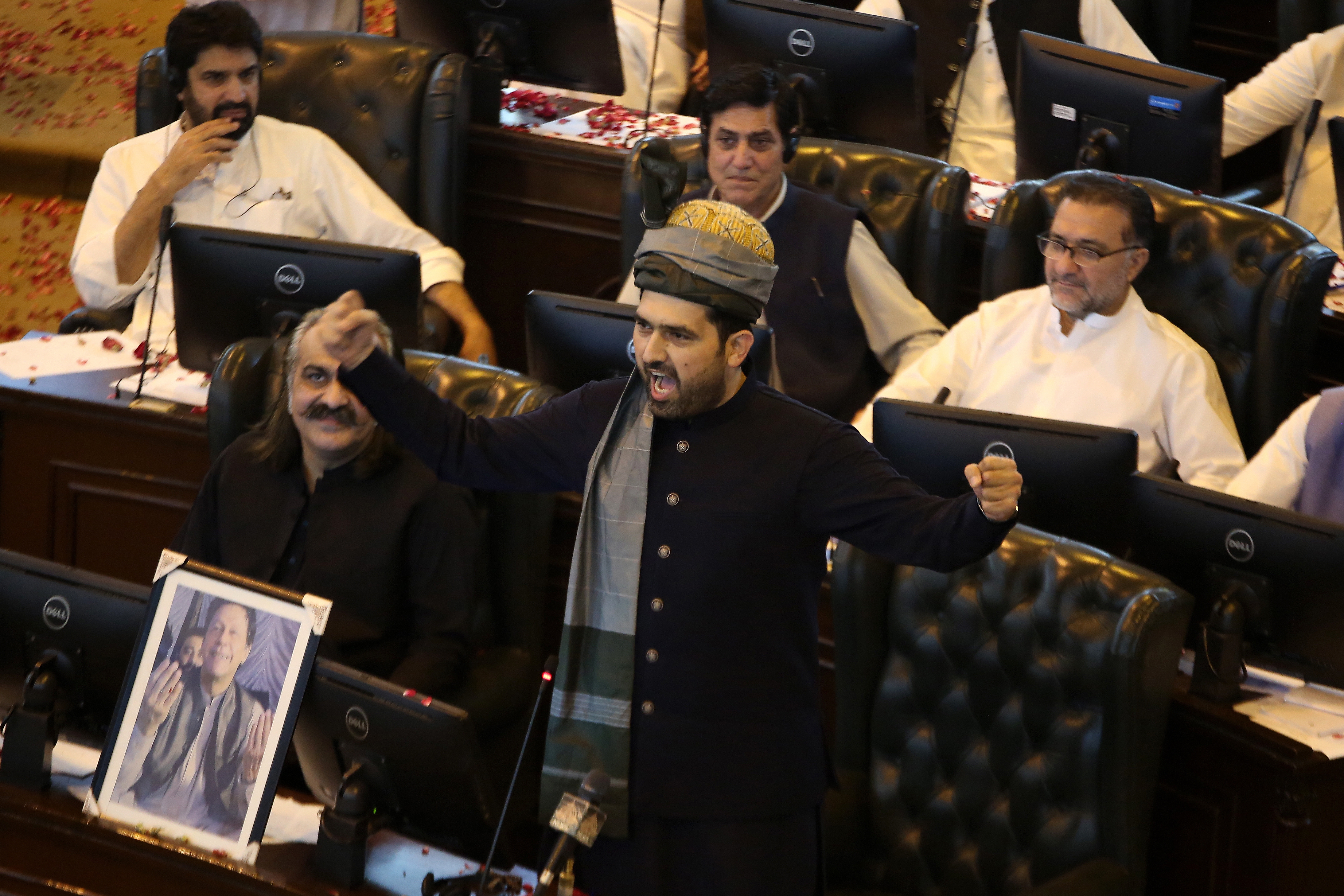 epa12451797 Sohail Afridi (R), of Pakistan Tehreek-e-Insaf (PTI), with former CM Ali Amin Gandapur (L) in front of a portrait of jailed former Prime Minister Imran Khan, talks with assembly members after being elected the new Chief Minister of Khyber Pakhtunkhwa province in Peshawar, Pakistan, 13 October 2025. Pakistan Tehreek-e-Insafs Sohail Afridi was elected chief minister of Khyber Pakhtunkhwa on Monday, securing 90 votes in the provincial assembly session held amid tight security in Peshawar. His election came after days of political uncertainty following former Chief Minister Ali Amin Gandapurs resignation and opposition concerns over the voting process. With 73 votes needed for a simple majority in the 145-member house, Afridis decisive win reaffirmed PTIs strong grip on the province. EPA/ARSHAD ARBAB
