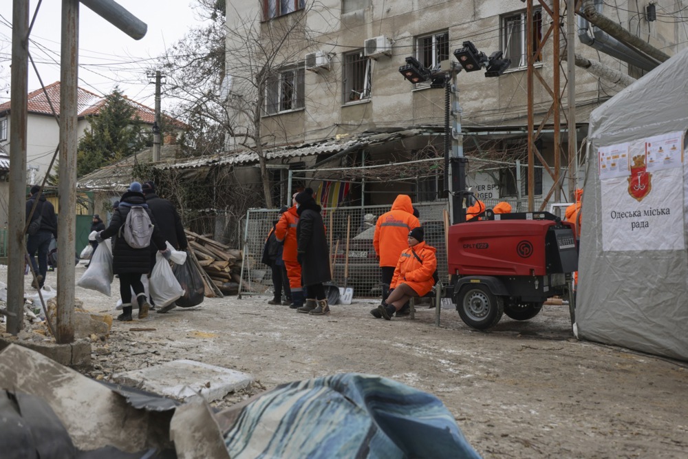 epa12704290 Ukrainian rescuers and communal workers at the site of a Russian drone strike on a residential building in Odesa, Ukraine, 04 February 2026. At least four people were injured as a result of the drone strike on a residential area, according to the State Emergency Service report. EPA/IGOR MASLOV