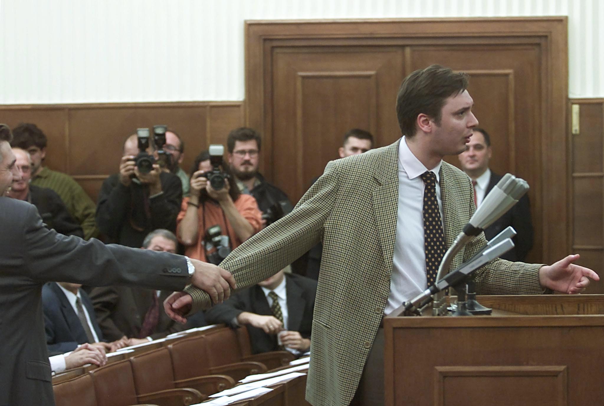 Former Serbian Information Minister Aleksandar Vucic (R) of the ultra-nationalist Serbian Radicals is held by the Secretary General of the Serbia's ruling Socialist Party, Zoran Andjelkovic, as he argues with the parliament speaker Dragan Tomic, in Belgrade October 23, 2000. The Serbian Parliament continued its session on Saturday in a bid to appoint the new transitional government and call the early parliament polls. Ousted Yugoslav President Slobodan Milosevic re-emerged on the Yugoslav political scene as his allies and their opponents haggled earlier on Saturday over the formation of a new government for Serbia, the country's dominant republic.GOT/CRB