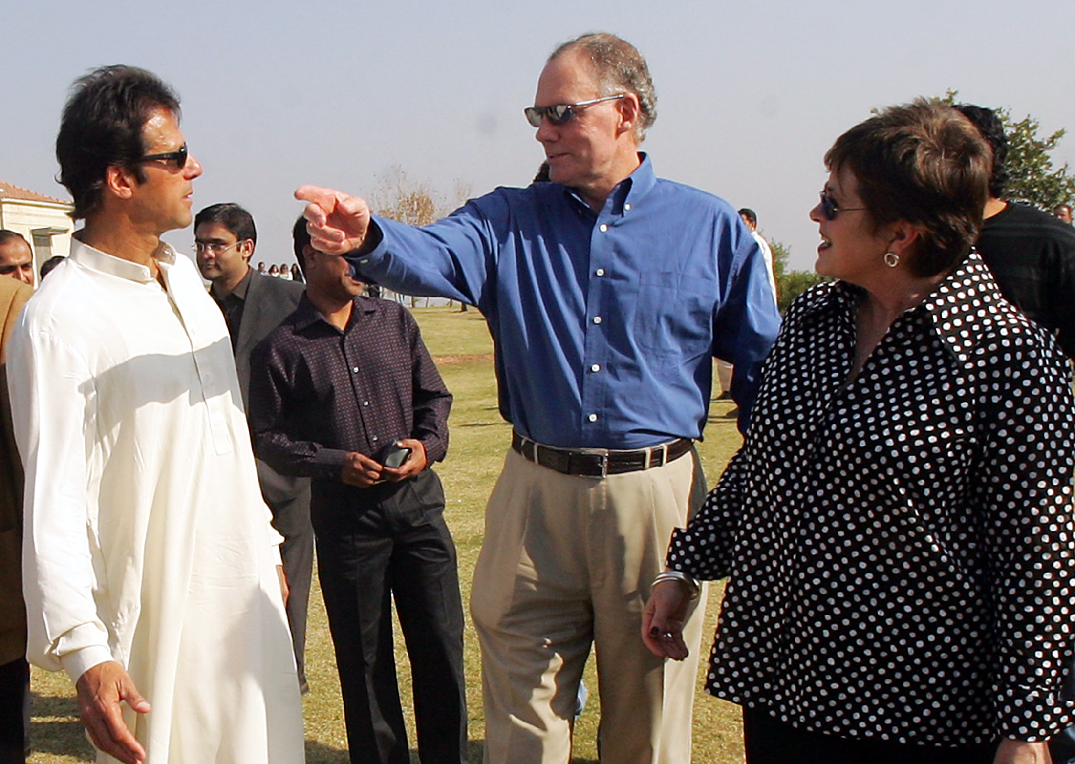 Former Pakistani cricket player Imran Khan (L) welcomes India's coach Greg Chappell (C) and his wife Judy to his residence for a luncheon invitation for the Indian players in Islamabad February 8, 2006. India and Pakistan will play their second one-day international in Rawalpindi, Pakistan, on Saturday. Pakistan won the first one-day international against India to take a 1-0 lead. REUTERS/Arko Datta