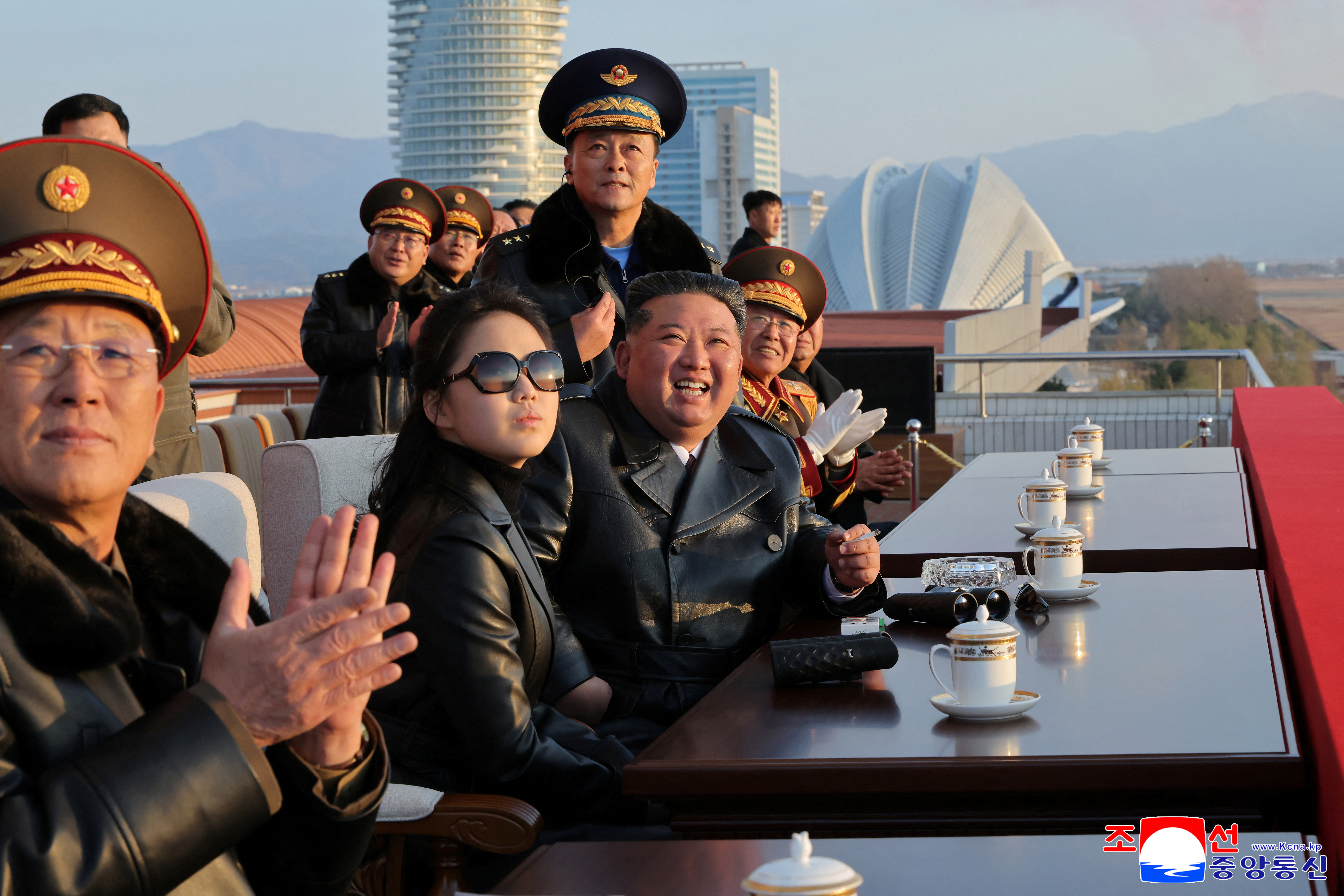 North Korean leader Kim Jong Un and his daughter Kim Ju Ae watch an air show during an event to celebrate the Air Force's 80th anniversary, at the Kalma Airfield, in Wonsan, North Korea, November 28, 2025, in this picture released by North Korea's official Korean Central News Agency November 30, 2025. KCNA via REUTERS ATTENTION EDITORS - THIS IMAGE WAS PROVIDED BY A THIRD PARTY. REUTERS IS UNABLE TO INDEPENDENTLY VERIFY THIS IMAGE. NO THIRD PARTY SALES. SOUTH KOREA OUT. NO COMMERCIAL OR EDITORIAL SALES IN SOUTH KOREA.
