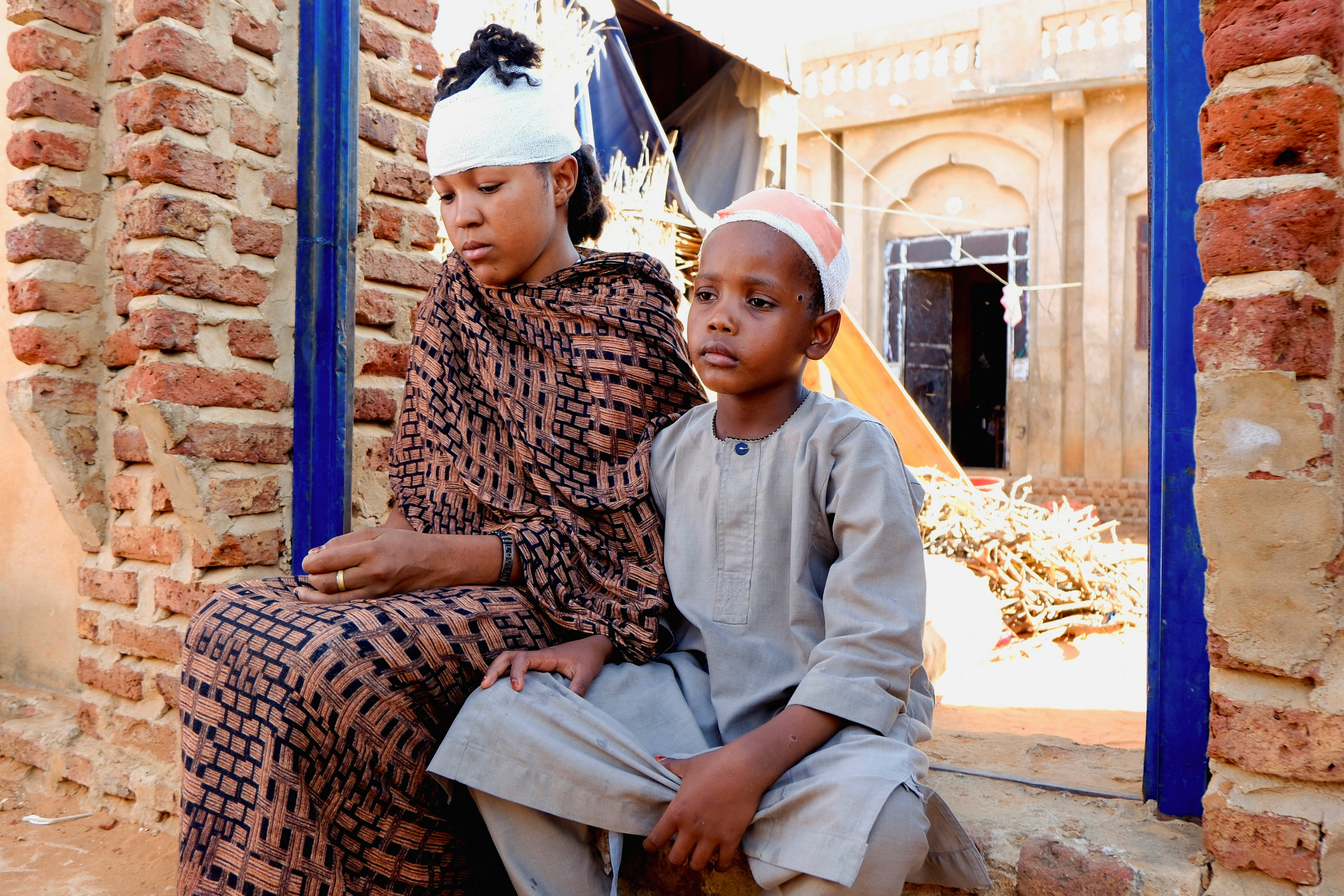 People injured during a drone strike sit in El Obeid, North Kordofan State, Sudan, January 12, 2026. REUTERS/El Tayeb Siddig