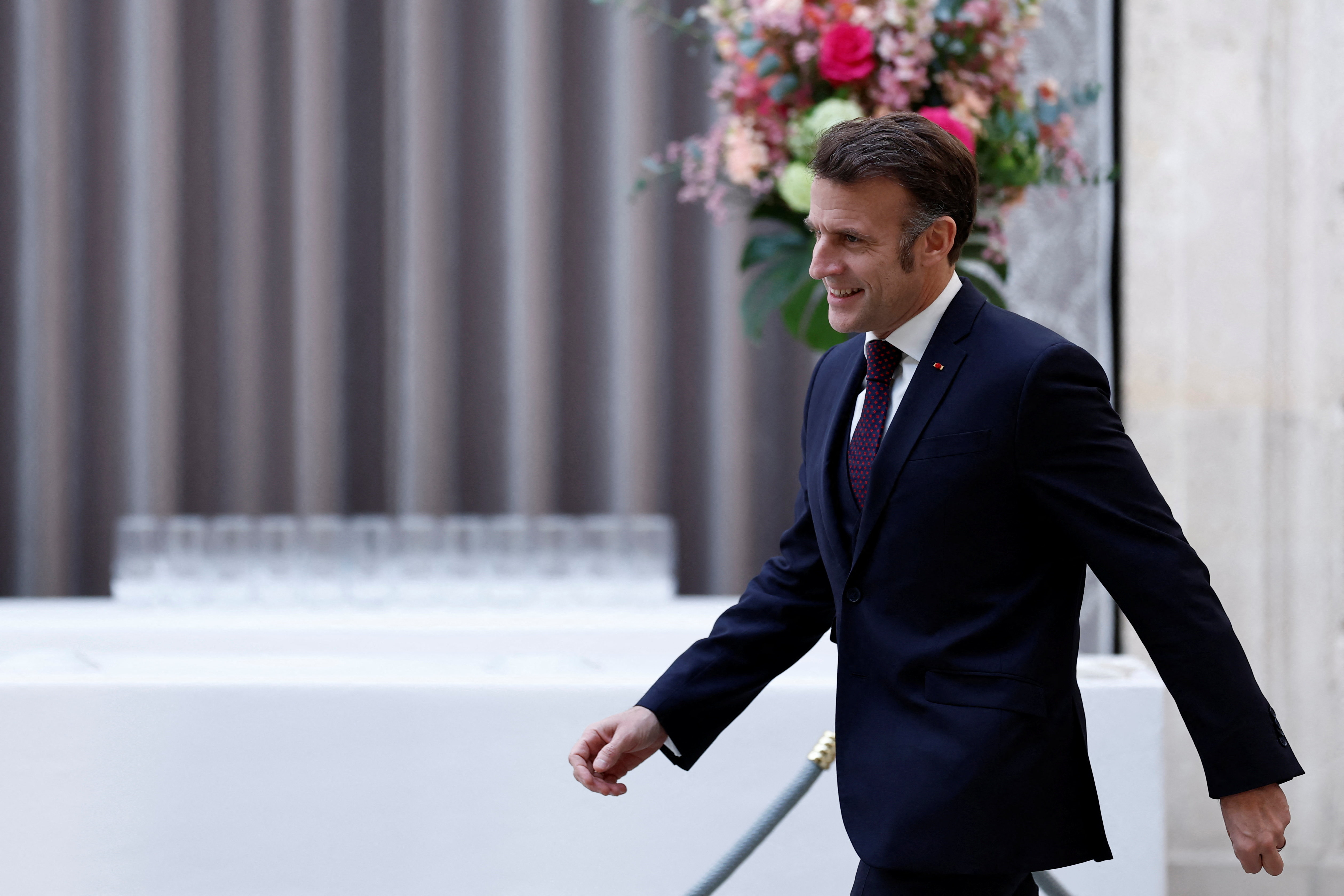 French President Emmanuel Macron walks.