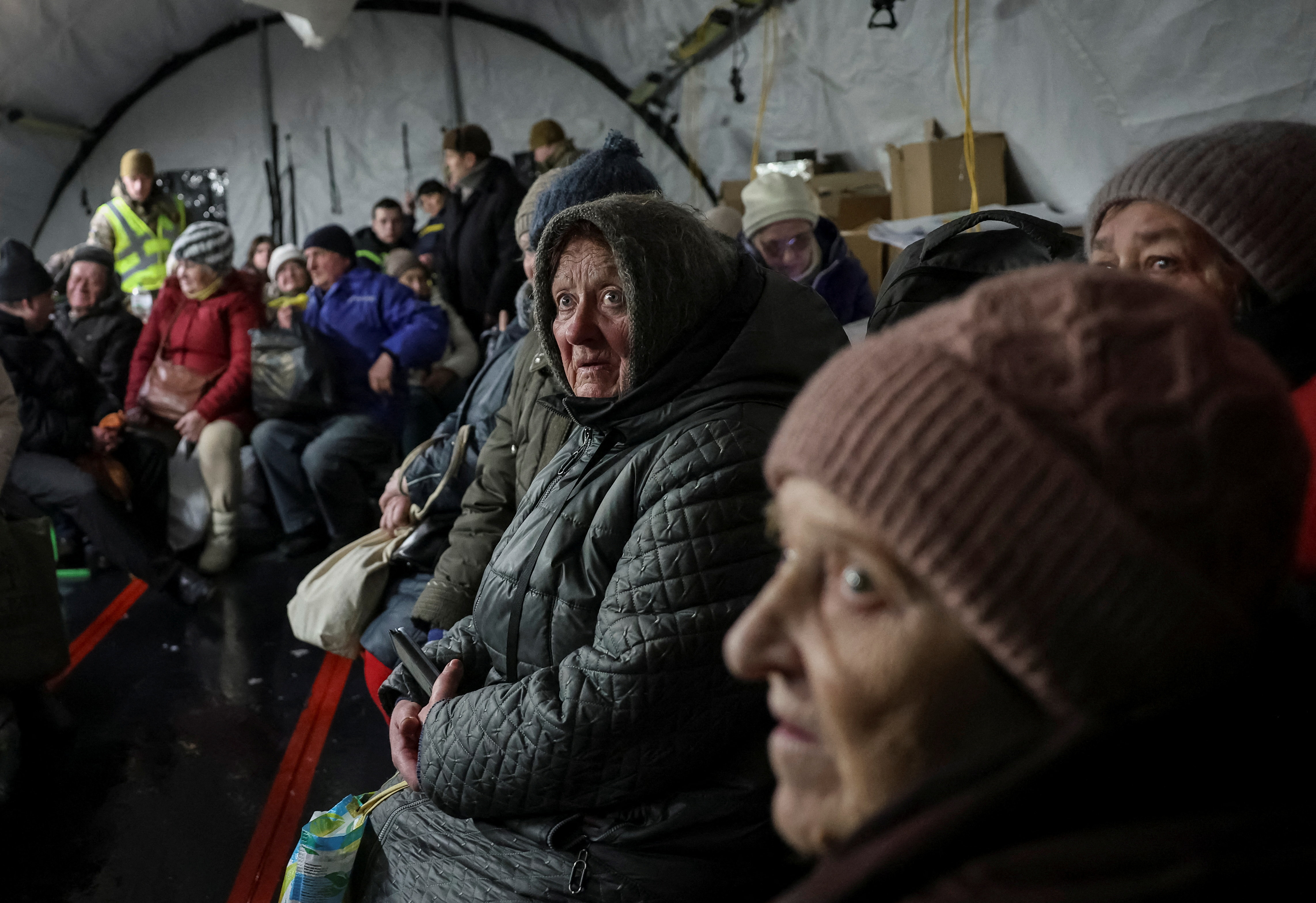 Residents wait for hot meals inside a tent at a government‑run humanitarian aid point, where people can warm up, charge their devices, get hot drinks and receive psychological support, during a power blackout after critical civilian infrastructure was hit by recent Russian missile and drone strikes, amid Russia's attack on Ukraine, in Kyiv, Ukraine February 7, 2026. REUTERS/Anatolii Stepanov