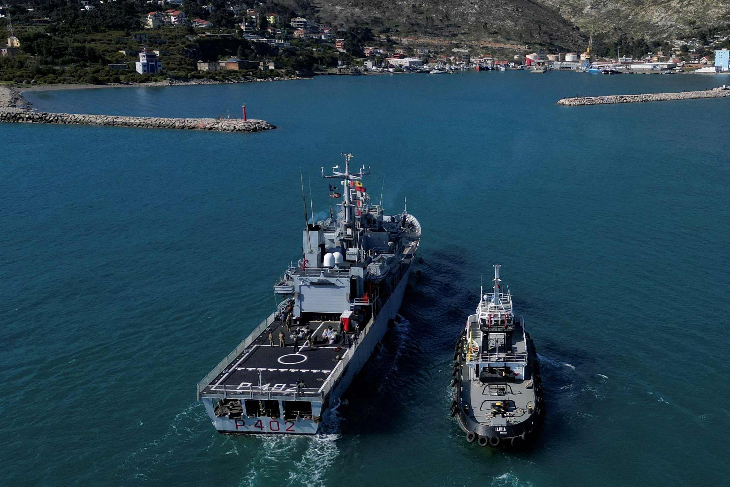 FILE PHOTO: A drone view shows the Italian navy ship Libra, carrying migrants as part of a deal with Italy to process asylum-seekers caught near Italian waters, as it arrives in Shengjin, Albania, April 11, 2025. REUTERS/Florion Goga/File Photo