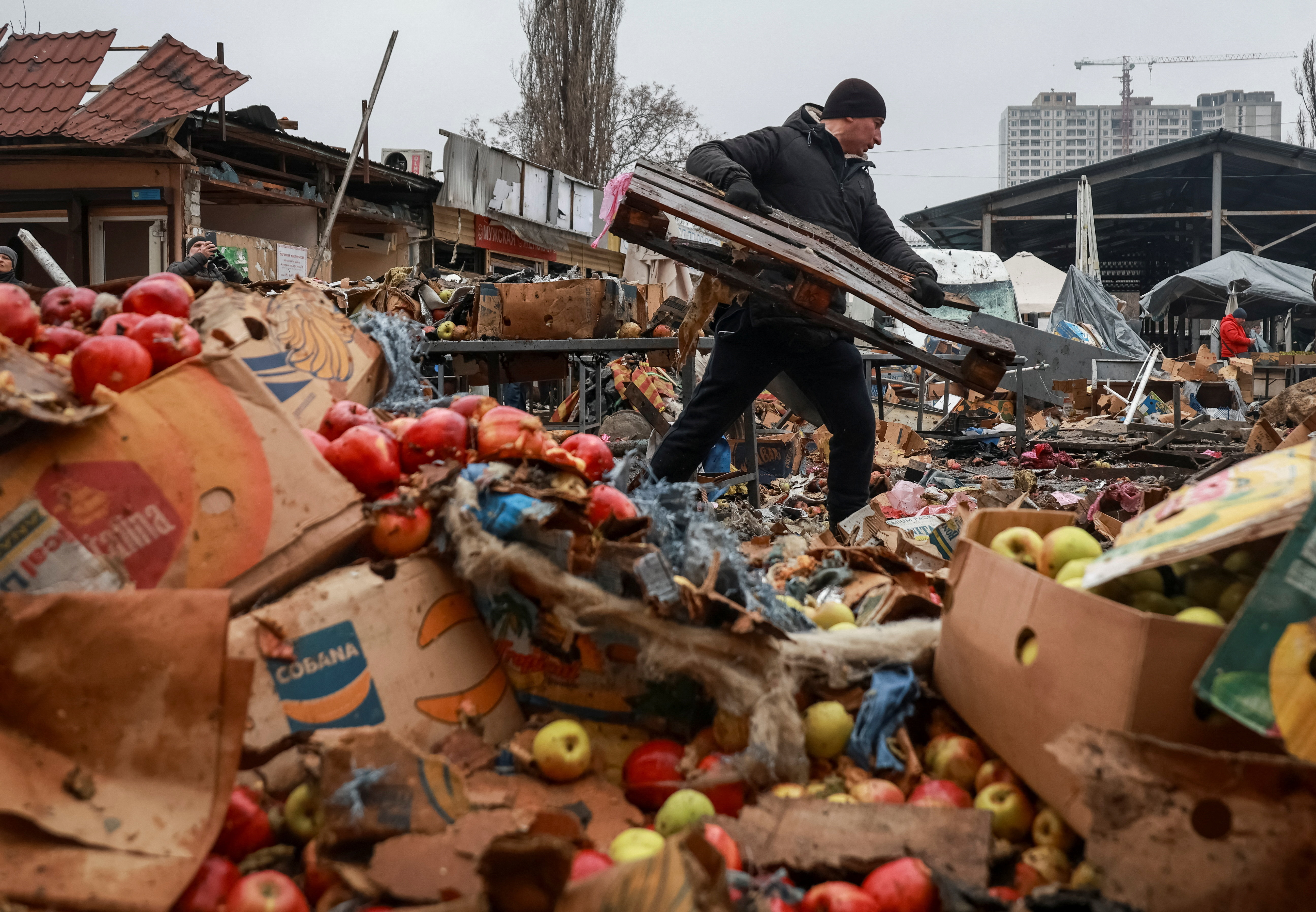 A vendor cleans an area at a street market hit by a Russian drone strike, amid Russia's attack on Ukraine, in Odesa, Ukraine February 12, 2026. REUTERS/Nina Liashonok TPX IMAGES OF THE DAY