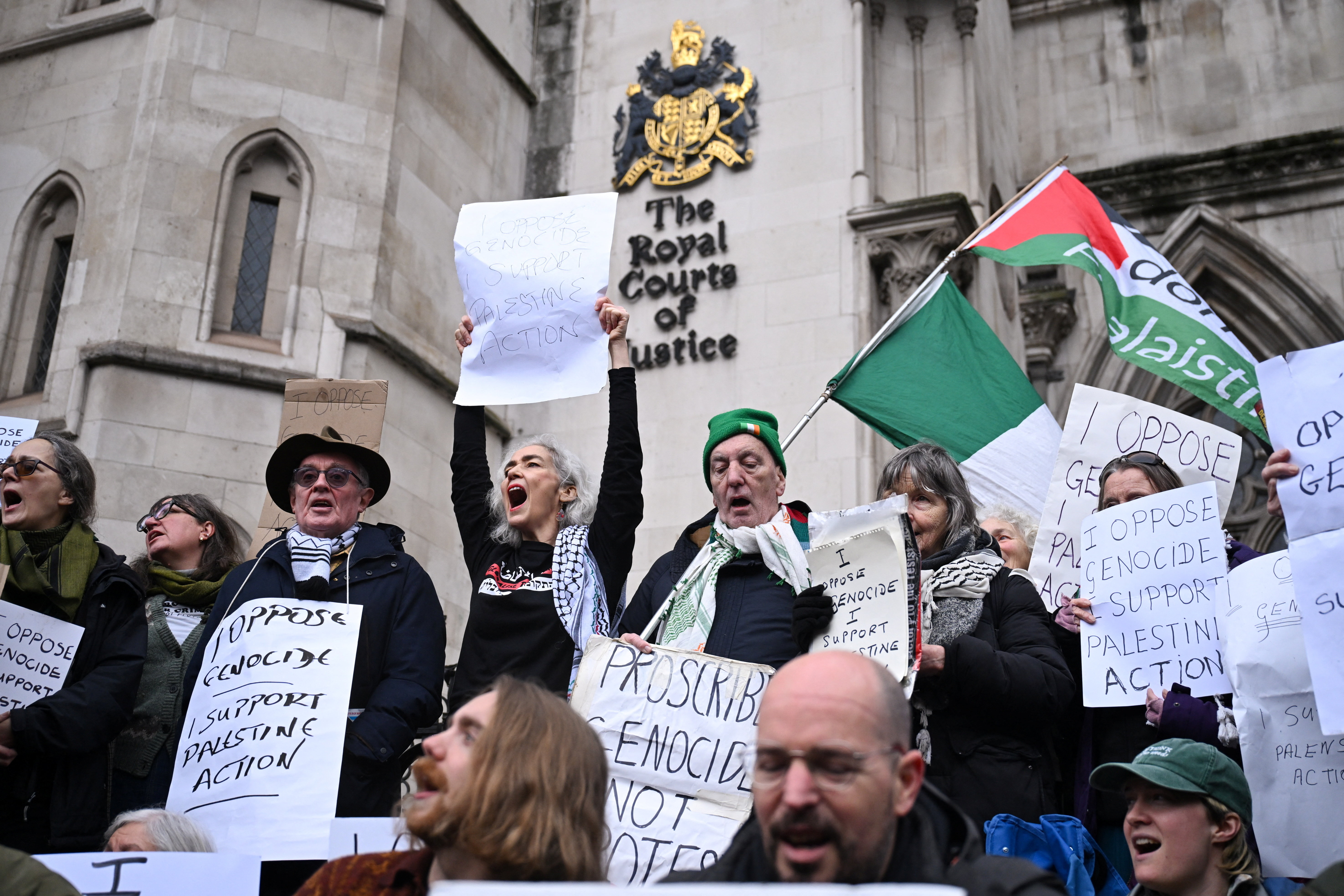 Protesters hold signs outside the Royal Courts of Justice, after High Court judges ruled the British government’s decision to designate pro‑Palestinian group Palestine Action as a terrorist organisation unlawful, in London, Britain, February 13, 2026. [Jaimi Joy/Reuters]