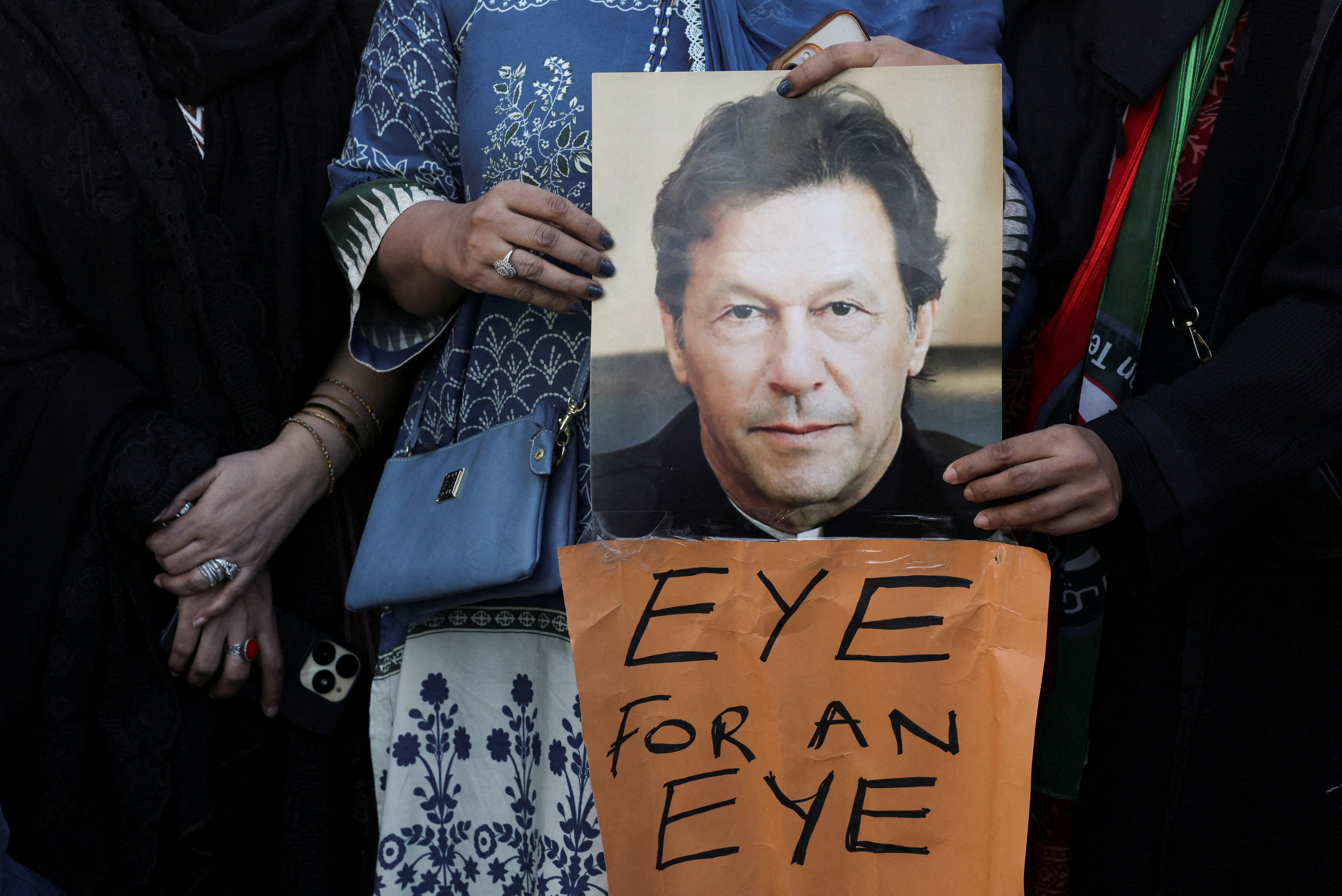 Supporters of jailed former Prime Minister Imran Khan's Pakistan Tehreek-e-Insaf (PTI) party carry a poster of him during a protest over concerns about their leader's health in Karachi, Pakistan, February 13, 2026. REUTERS/Akhtar Soomro TPX IMAGES OF THE DAY