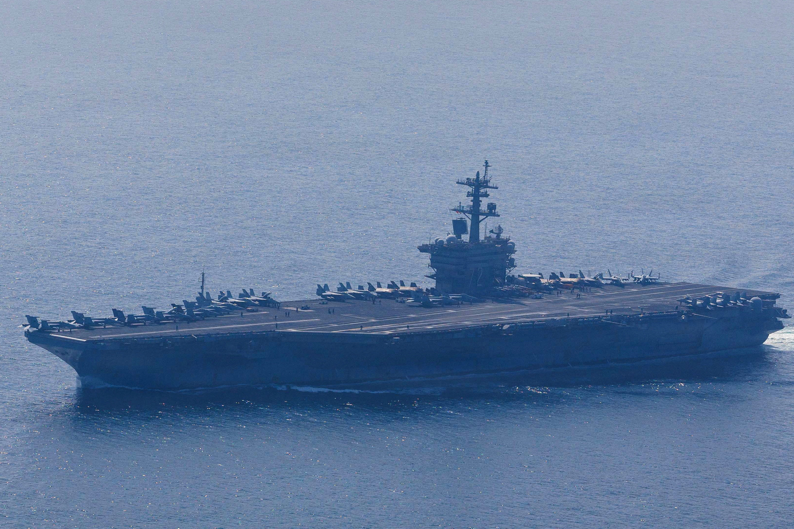 The U.S. Navy's Nimitz-class aircraft carrier USS Abraham Lincoln and Arleigh Burke-class guided-missile destroyer USS Frank E. Petersen Jr. sail during a photo exercise in the Arabian Sea, February 6, 2026. U.S. Navy/Mass Communication Specialist 1st Class Jesse Monford/Handout via REUTERS THIS IMAGE HAS BEEN SUPPLIED BY A THIRD PARTY