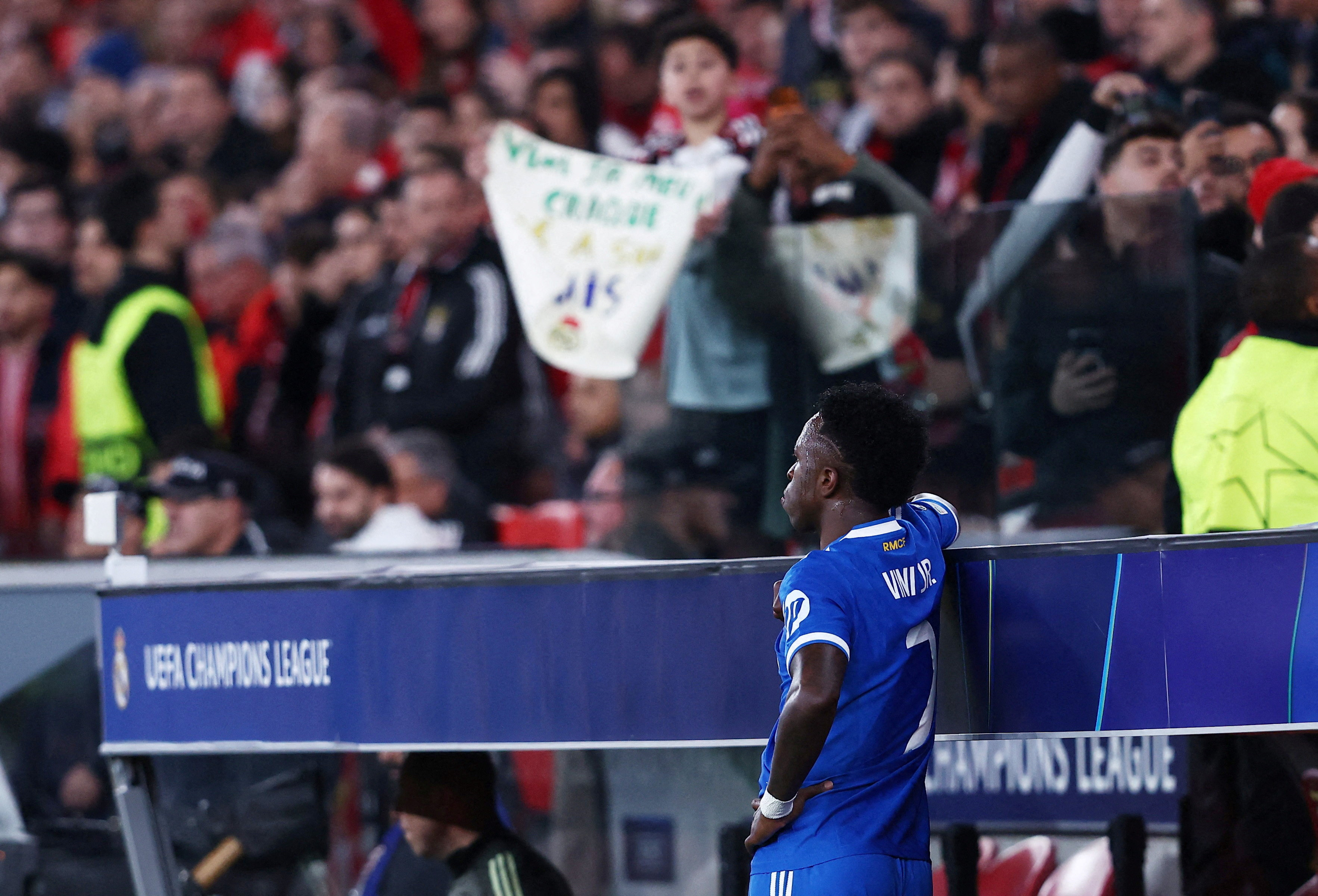 Real Madrid's Vinicius Junior looks on from the side of the pitch as the match was stopped due to racist chants