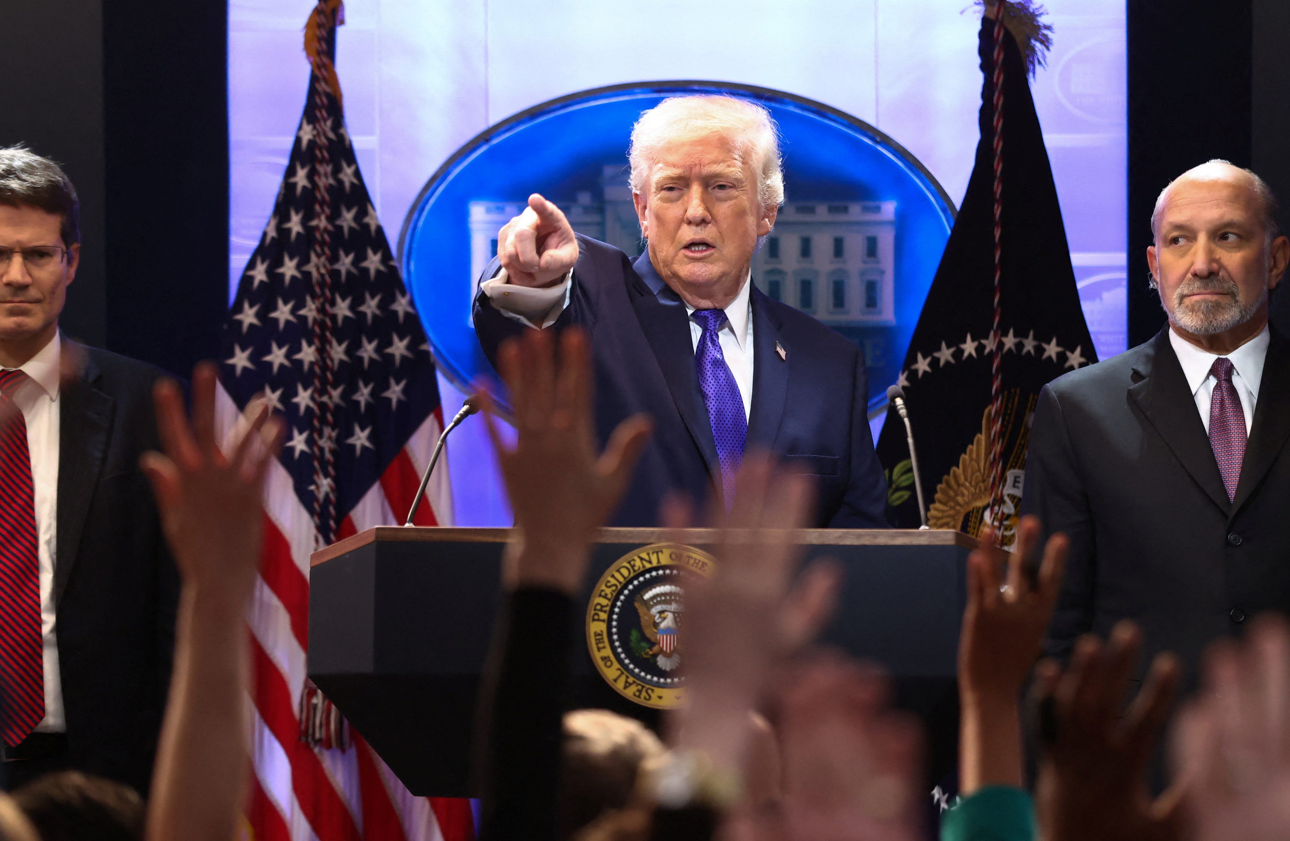 US President Donald Trump, flanked by Secretary of Commerce Howard Lutnick and Solicitor General D. John Sauer, holds a press briefing at the White House, following the Supreme Court's ruling that Trump had exceeded his authority when he imposed tariffs, in Washington, DC, January 20, 2026. [Jonathan Ernst/Reuters]