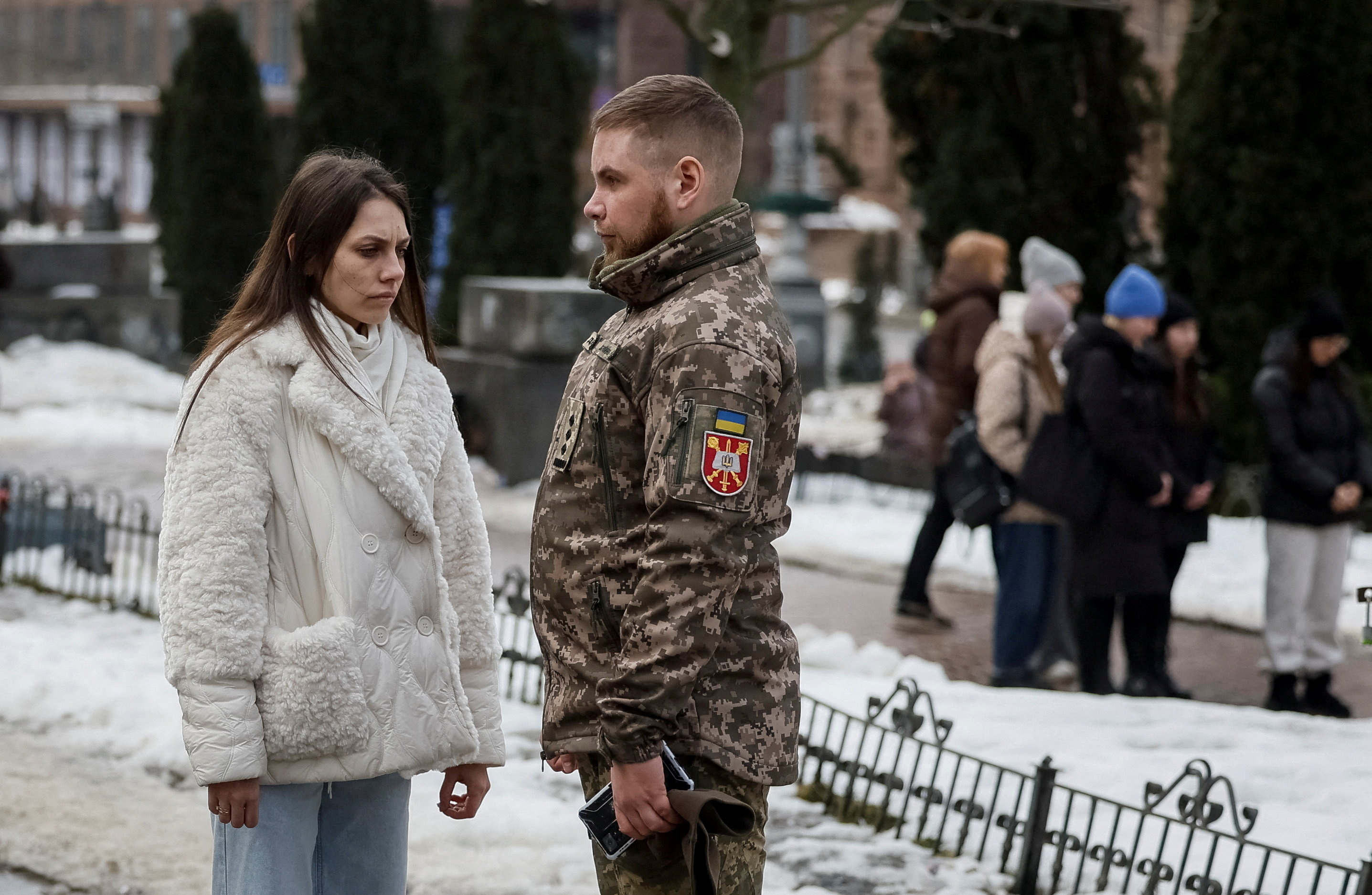 People stand during a minute of silence to mark the fourth anniversary of the full-scale Russian invasion, amid Russia's attack on Ukraine, in Kyiv, Ukraine February 24, 2026. REUTERS/Gleb Garanich TPX IMAGES OF THE DAY