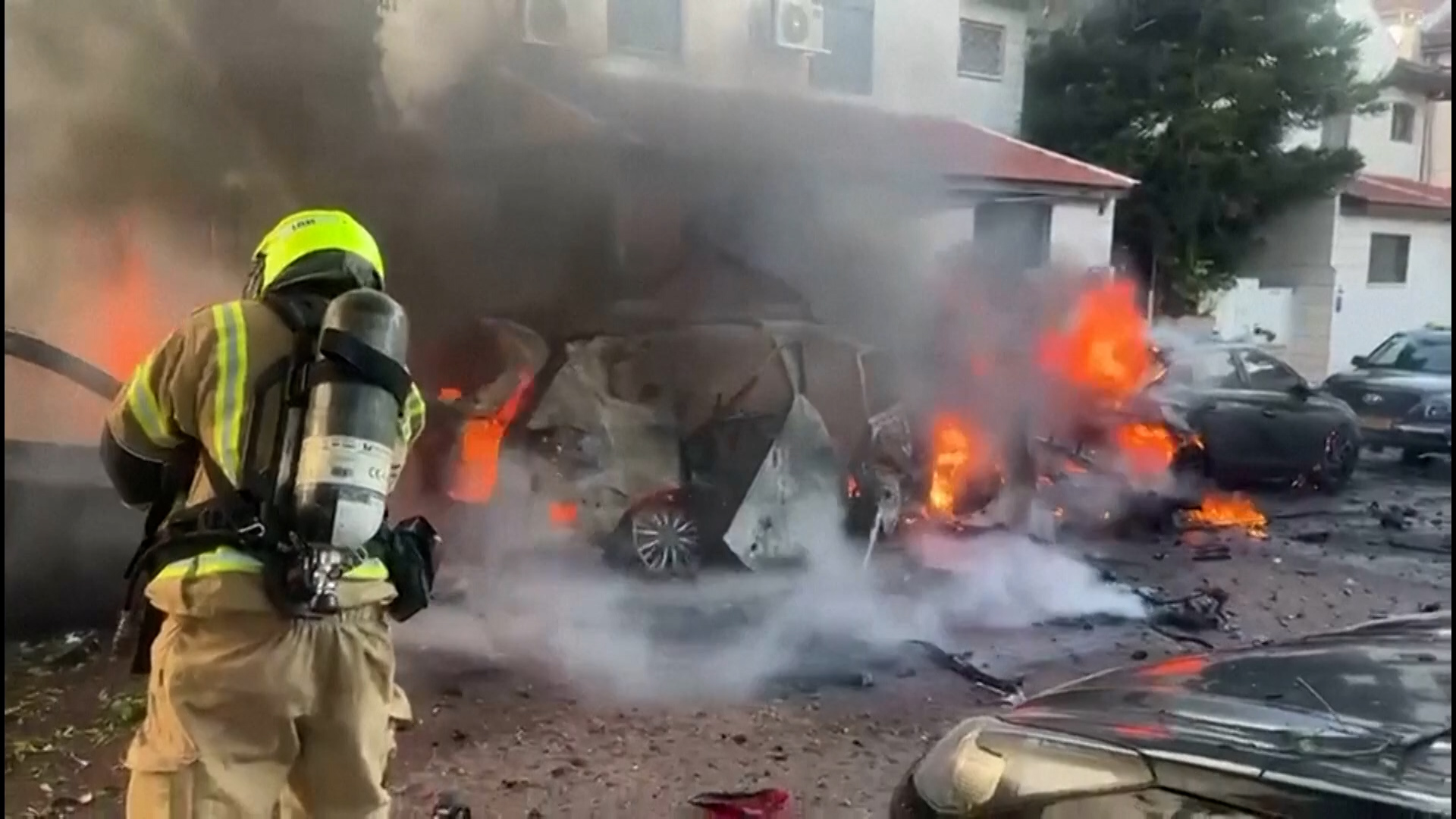 Firefighters extinguish several burning cars in central Israel after Iranian retaliation to joint US-Israeli strikes on February 28, 2026. [Screenshot via AFP]